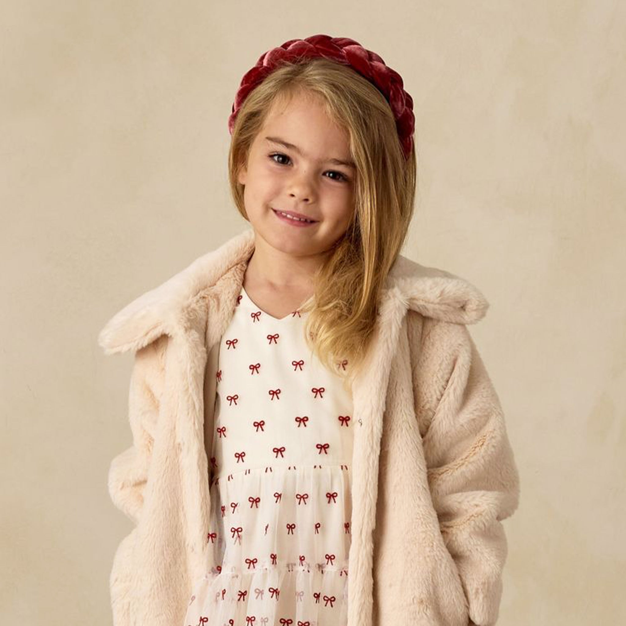 An ivory faux fur coat. 