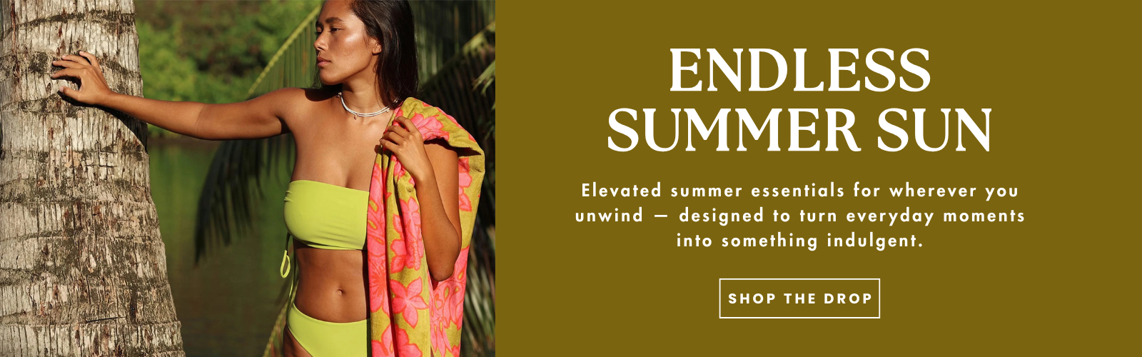 A website banner of a woman in a lime green bathing suit standing with a towel over her shoulder and palm trees in the distance.  The text on that banner reads, "endless summer sun- elevated summer essentials for wherever you unwind- designed to turn everyday moments into something indulgent."