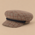 a brown and red and tan fiddler cap. 