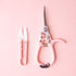 A pair of light pink pruning shears and mini plant snips. 
