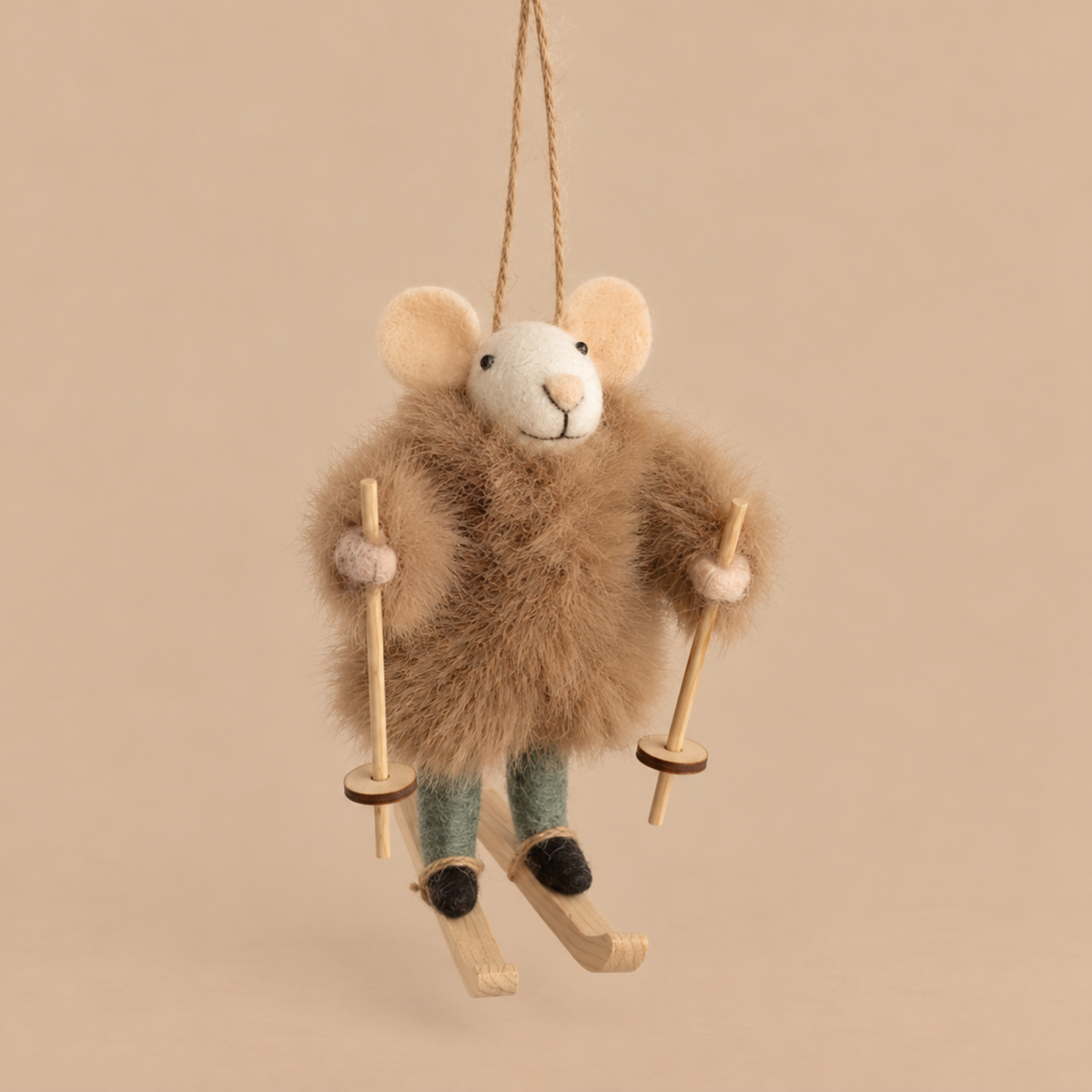 a felt mouse ornament wearing a brown fur coat and a pair of skis