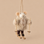 a felt mouse ornament wearing an oatmeal colored jacket and a pair of skis