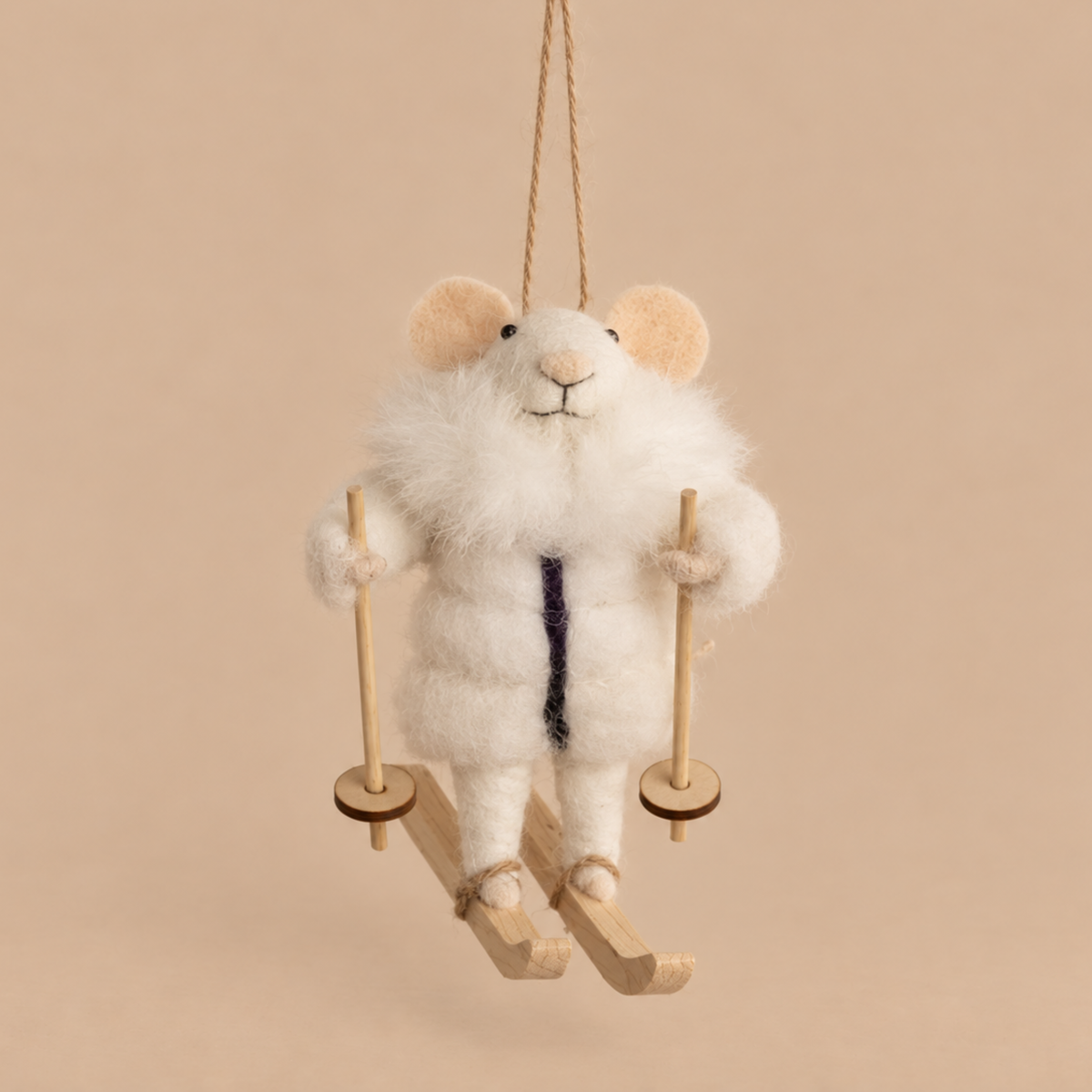 a felt mouse ornament wearing a white fur coat and skis