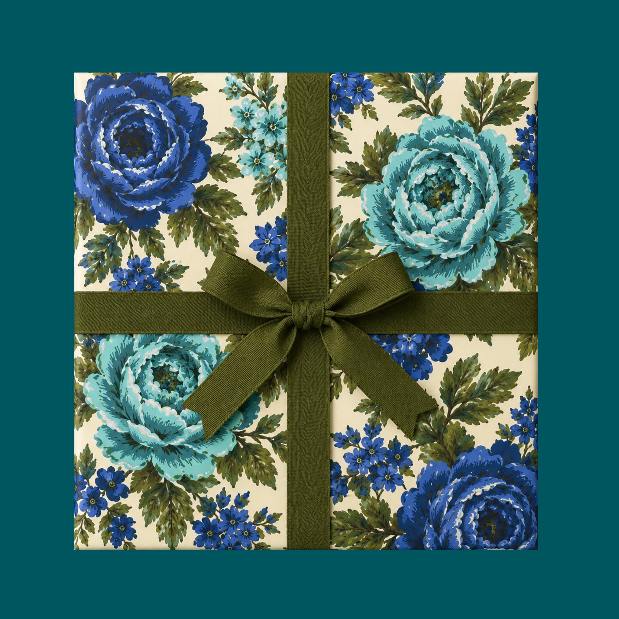 A package wrapped in a vintage blue floral wrapping paper with a green ribbon.