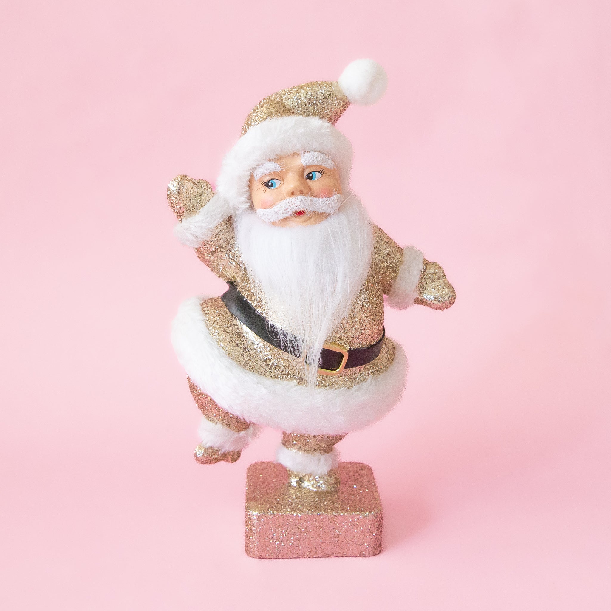 A gold glitter Santa figurine. 