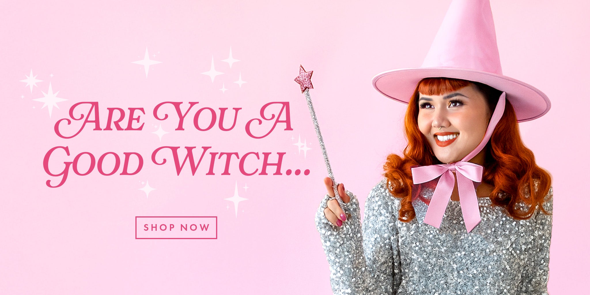 A pink web banner image of a model wearing a pink witch hat with red hair. The text next to her reads "are you a good witch..."