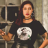 a model wearing a black tshirt with halloween tombstone design. 