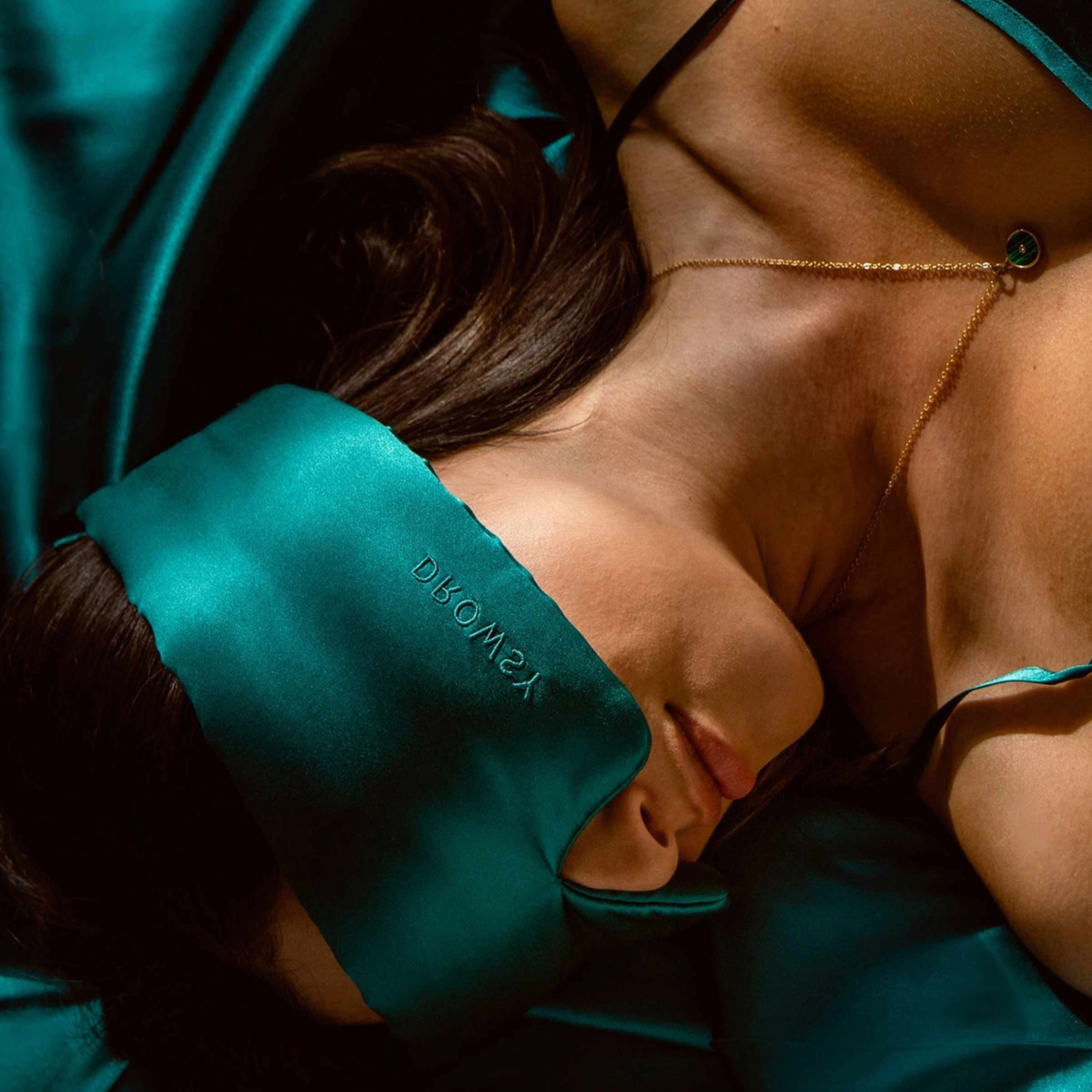 a sapphire green padded sleep mask. 