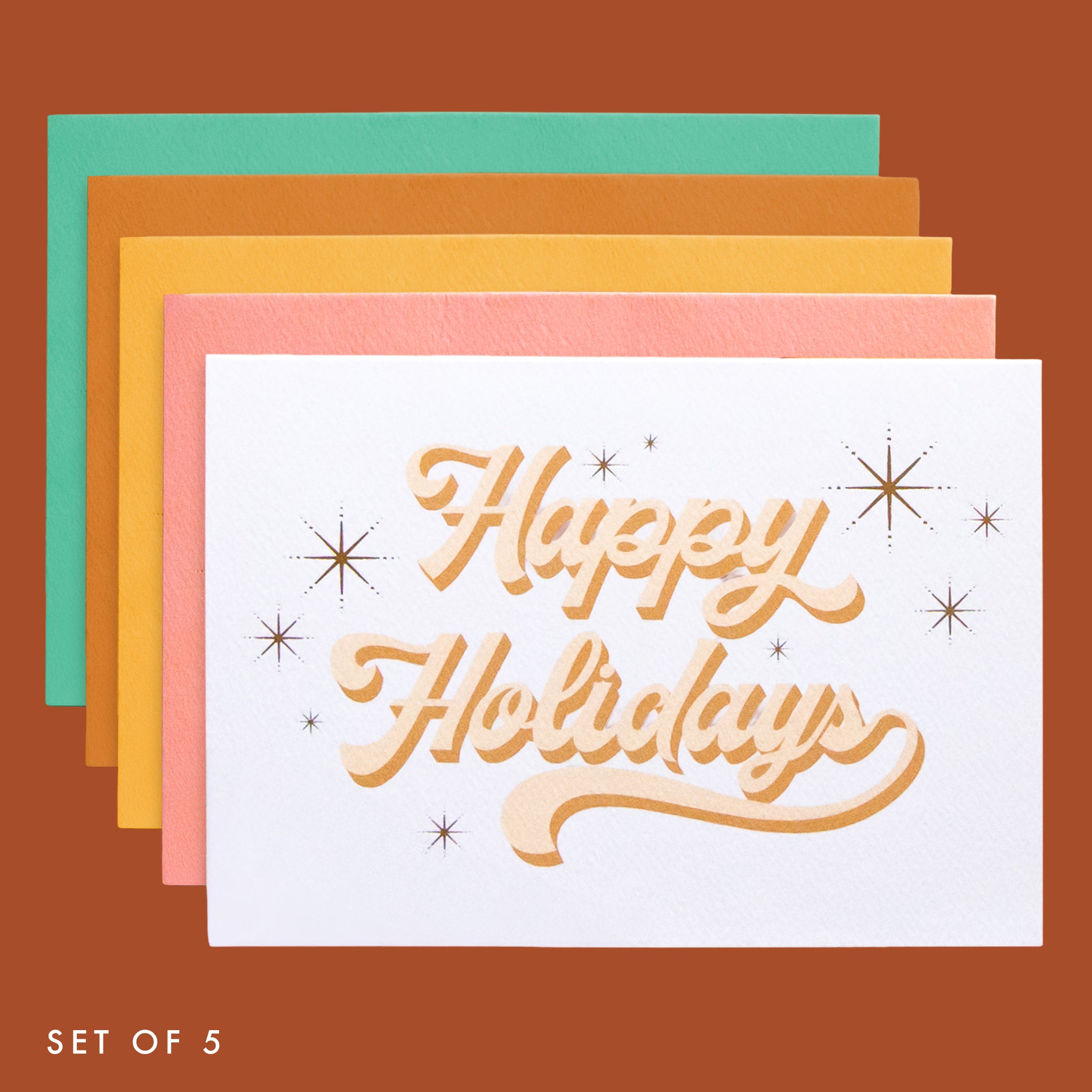 Five pack of holiday cards layered on top of each other in a parallel vertical row. The cards read 'happy Holidays' in cursive lettering. 