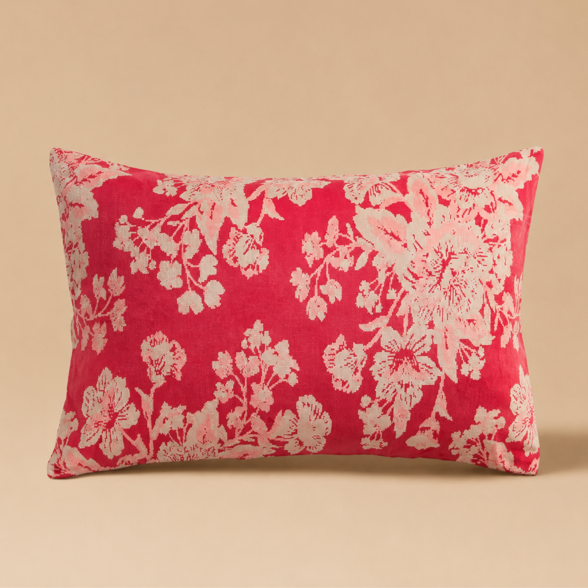 A cream and pink floral pillow