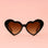 A black pair of heart shaped sunglasses. 
