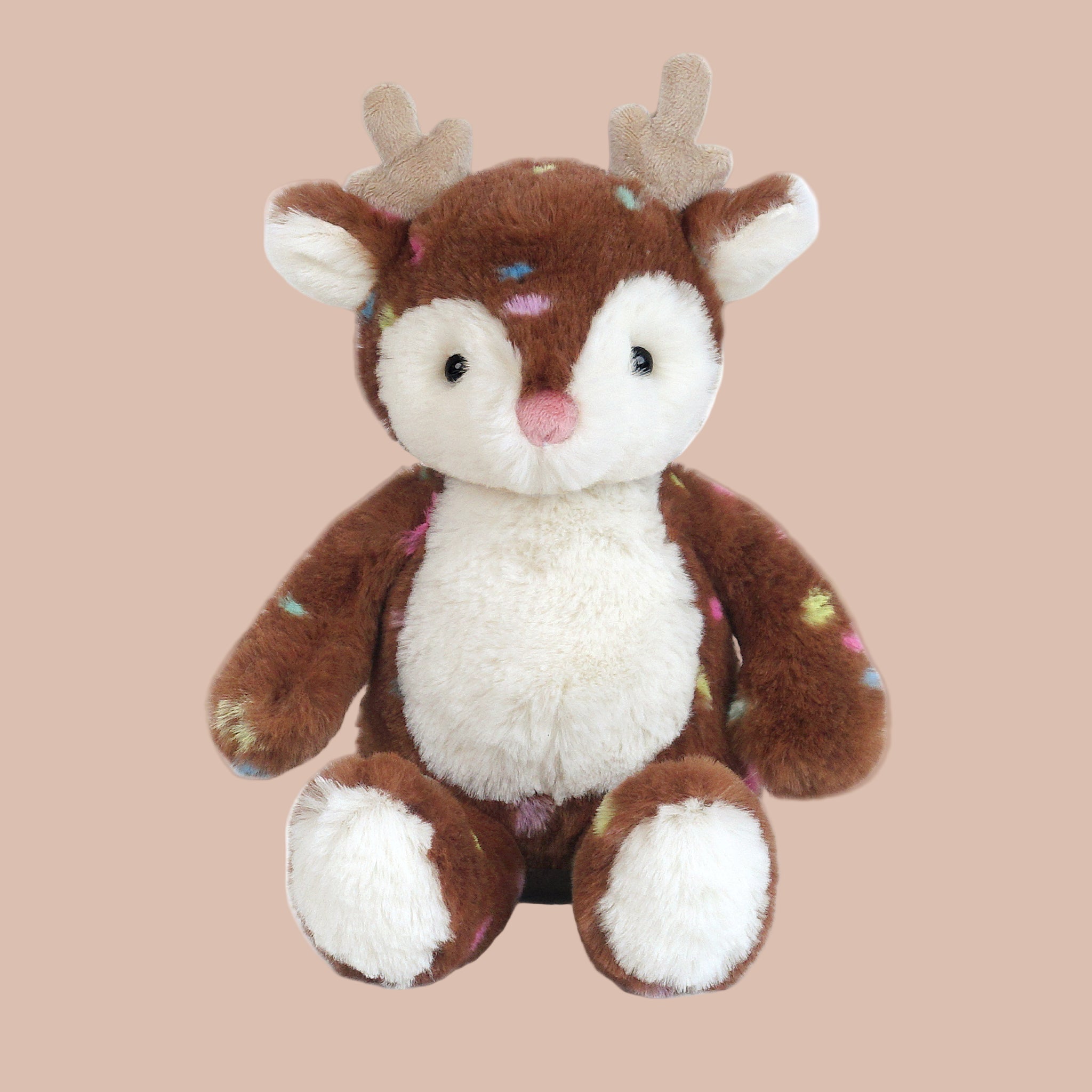 A brown reindeer shaped stuffed animal toy with multi colored spots. 