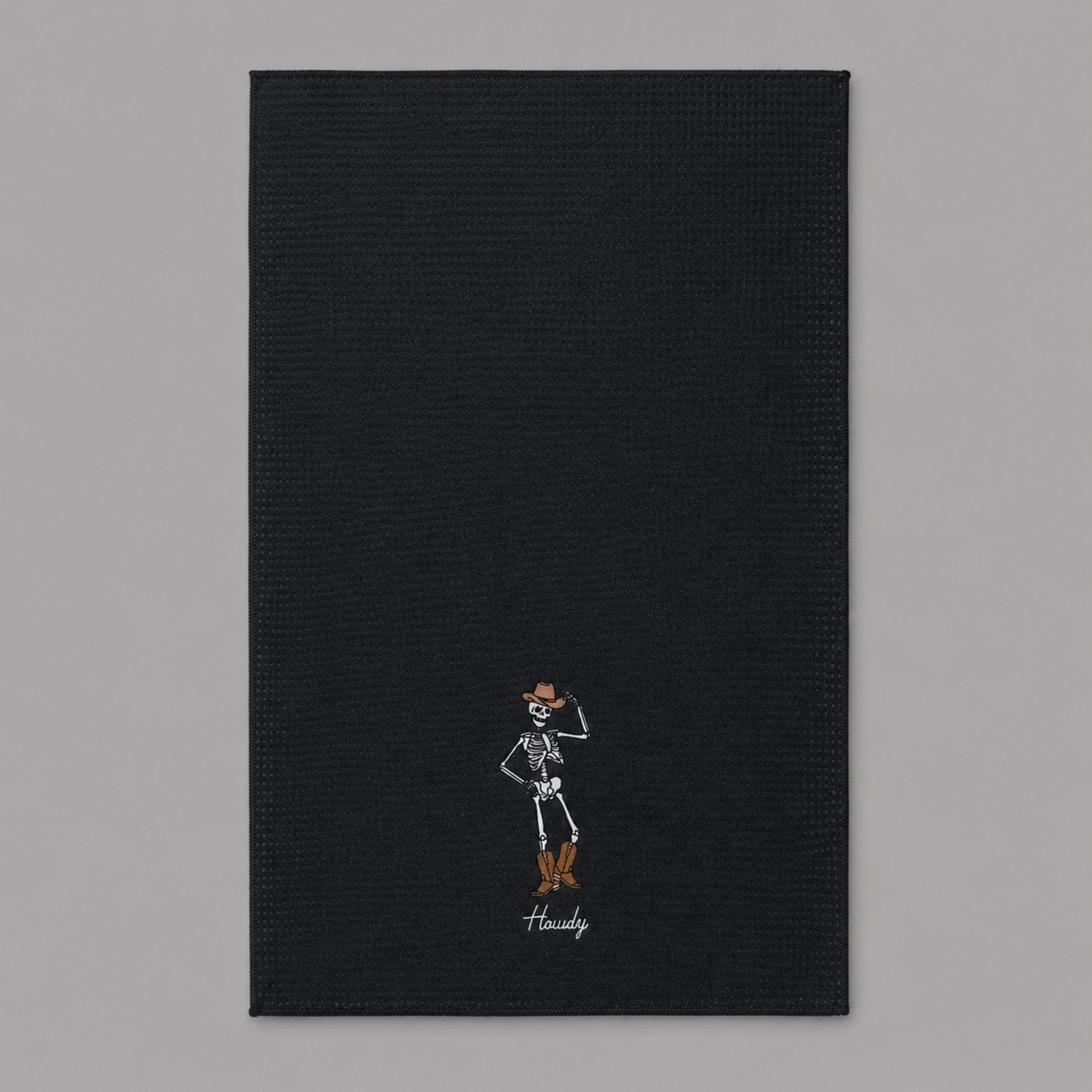 a black towel with a skeleton design on the bottom. 