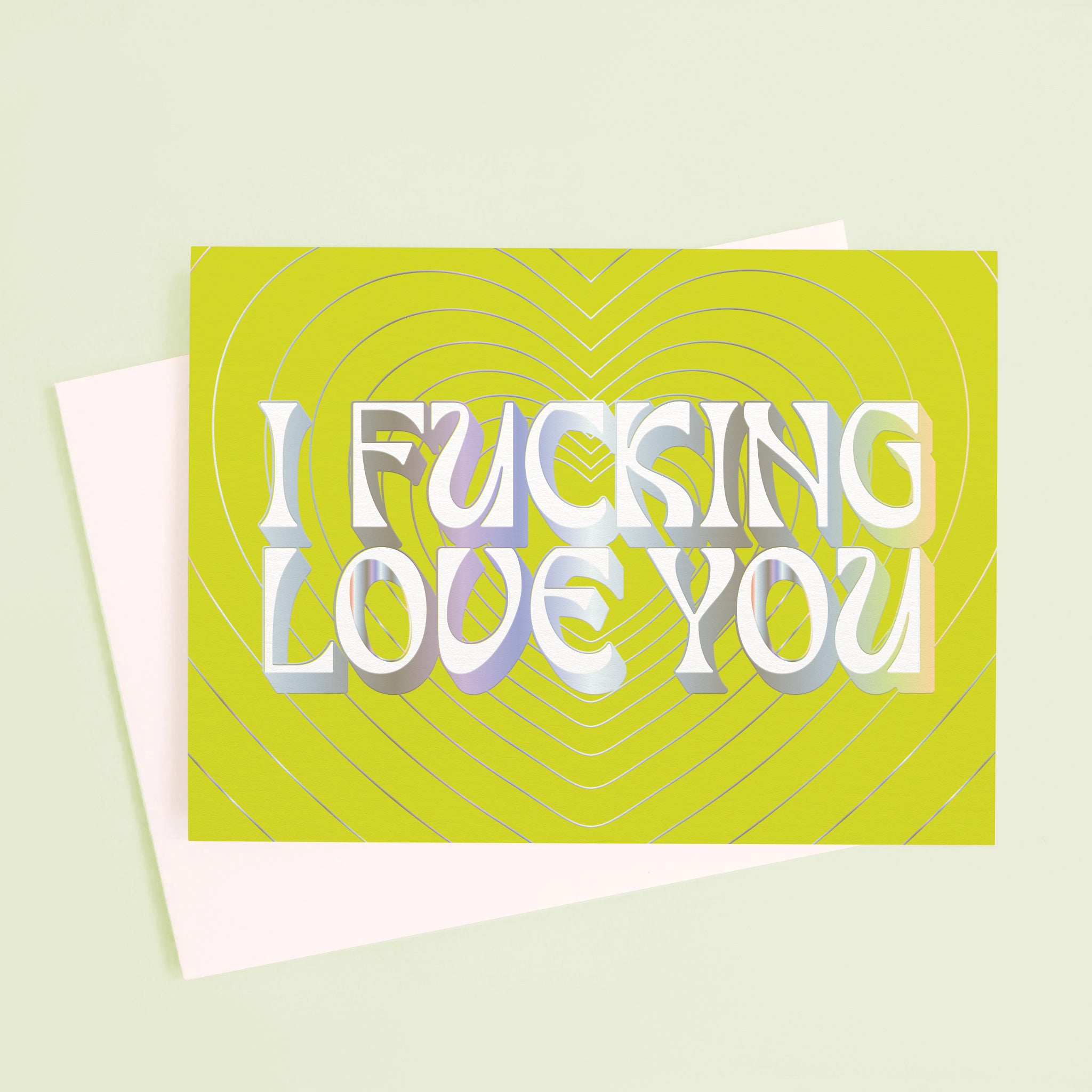 On a mint green background is a lime green card with silver heart shapes and text in the center that reads, "I Fucking Love You".