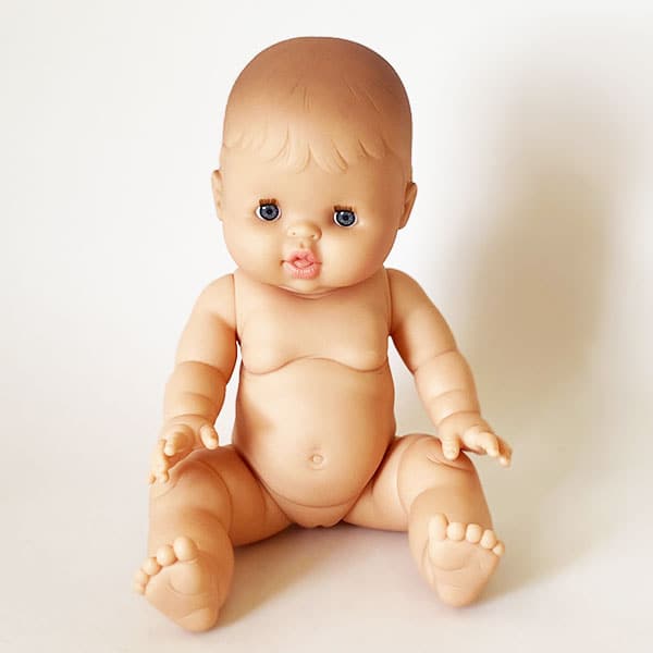A European babu girl doll photographed in front of a white background.