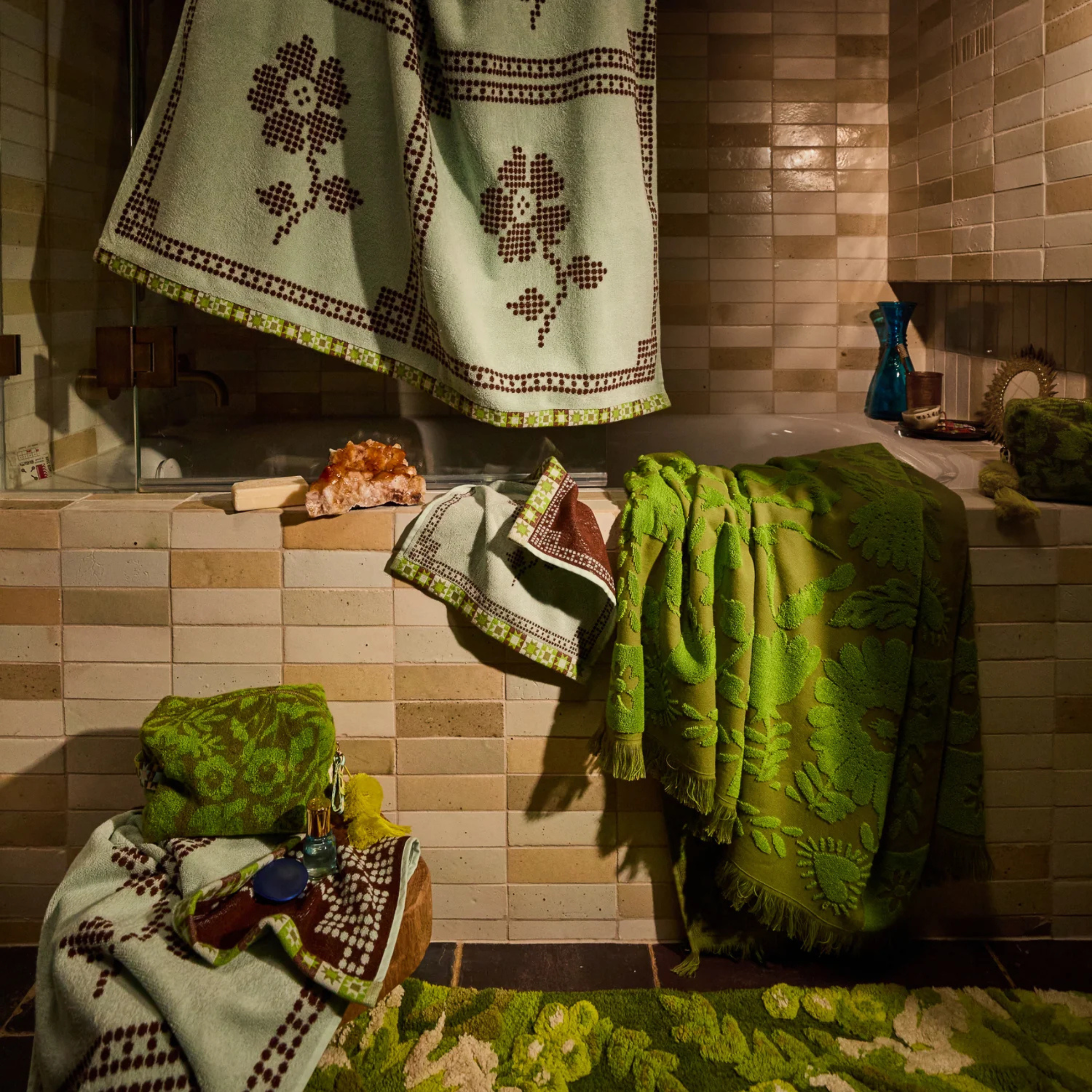 a green floral print reversible bath towel.
