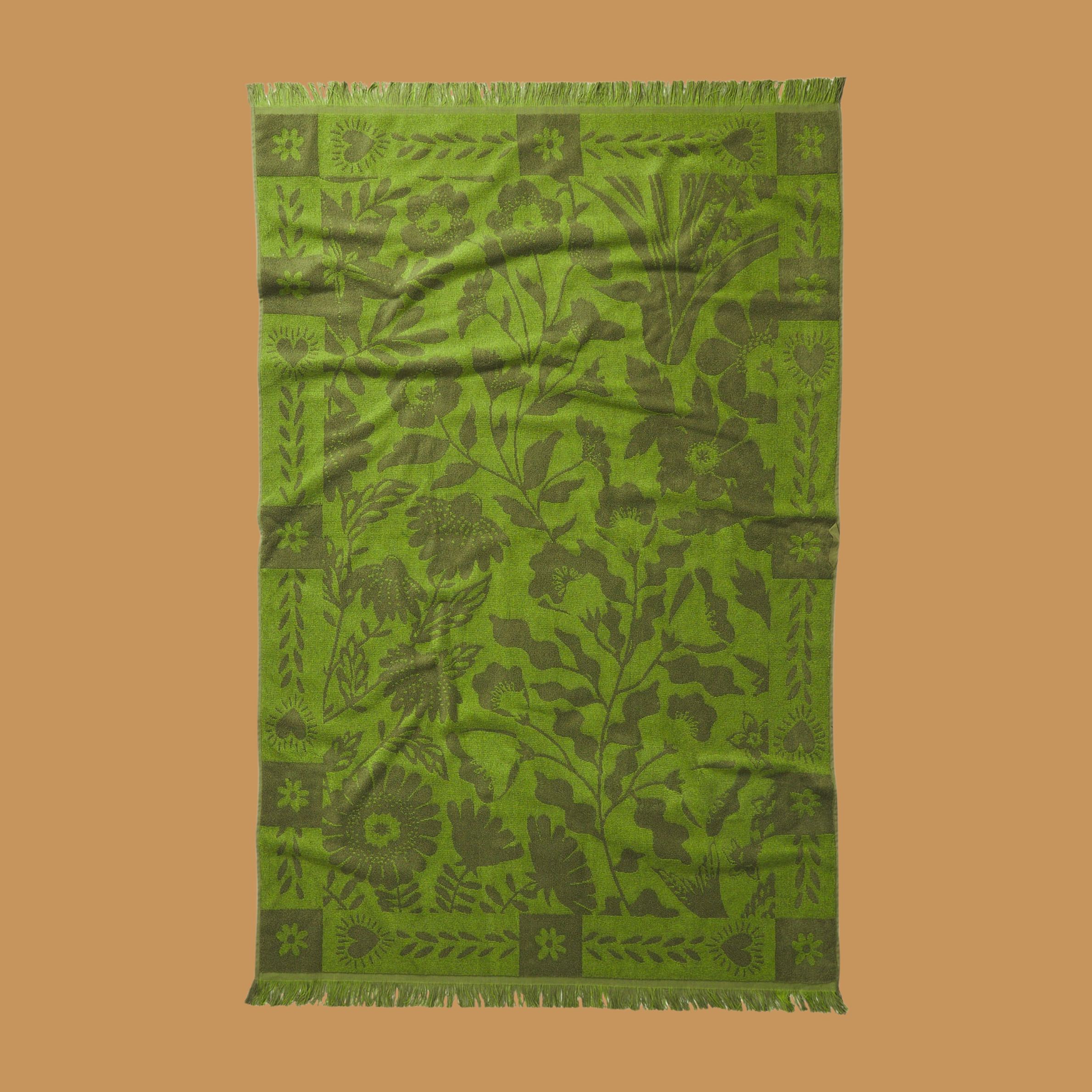 a green floral print reversible bath towel.