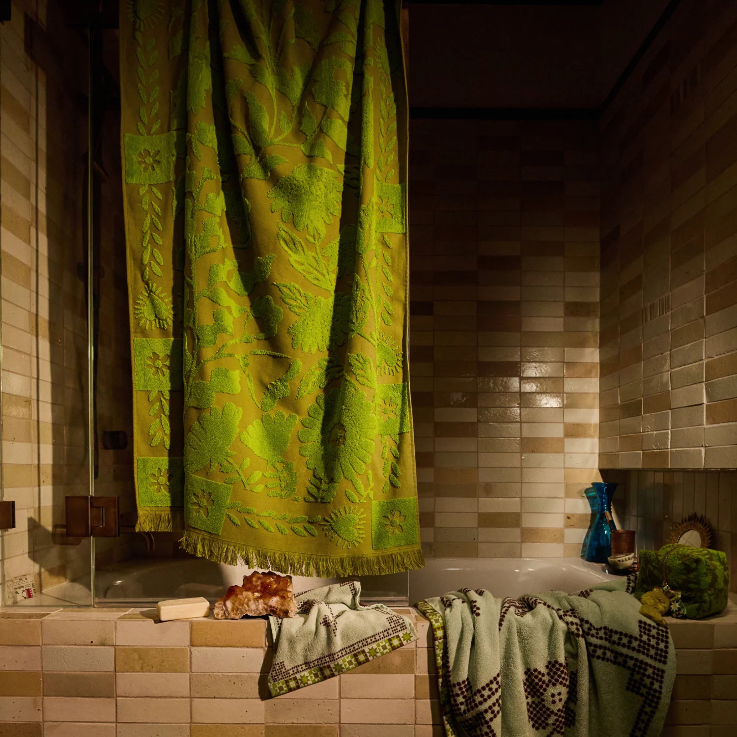 a green floral print reversible bath towel.