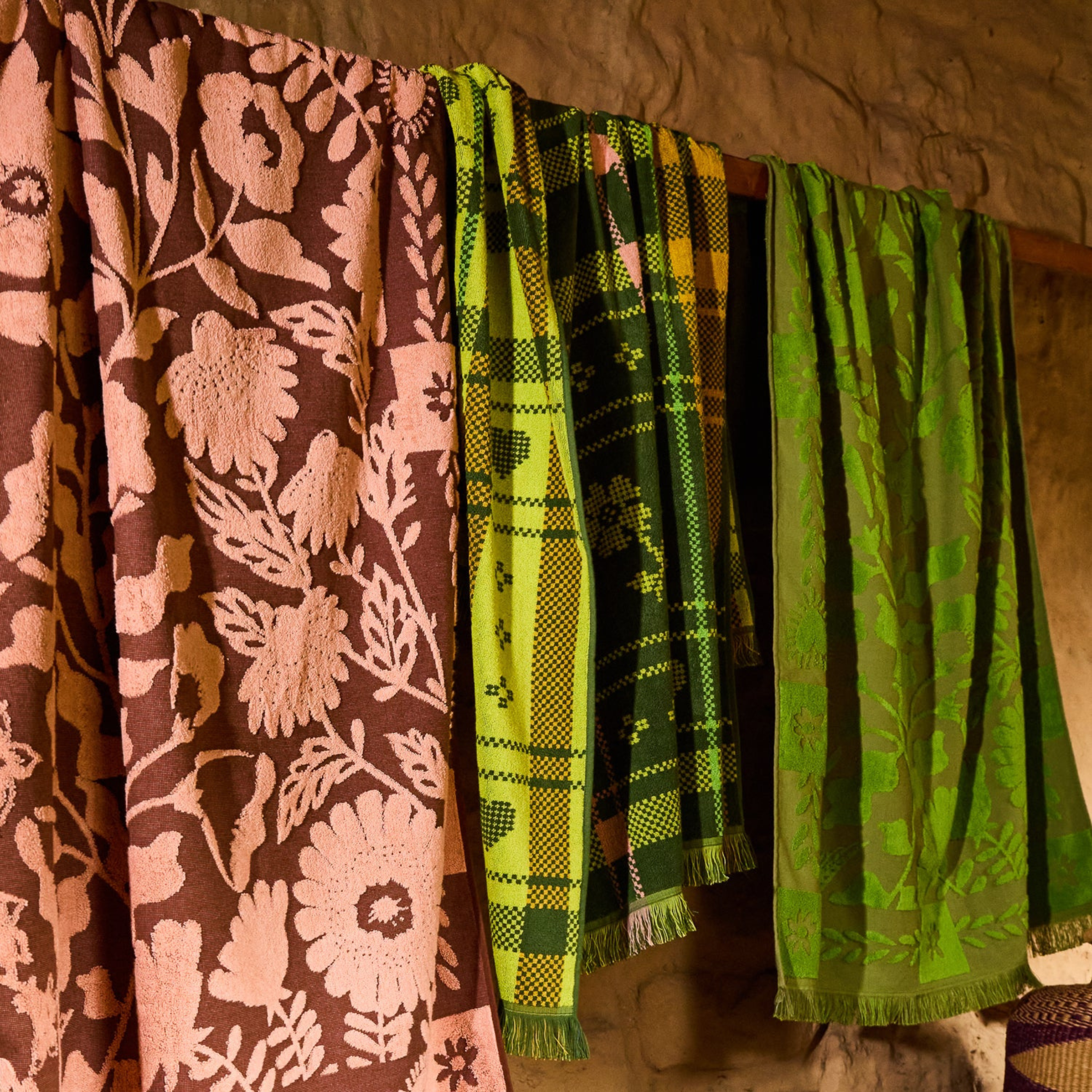 a burgundy and pink floral print bath towel.