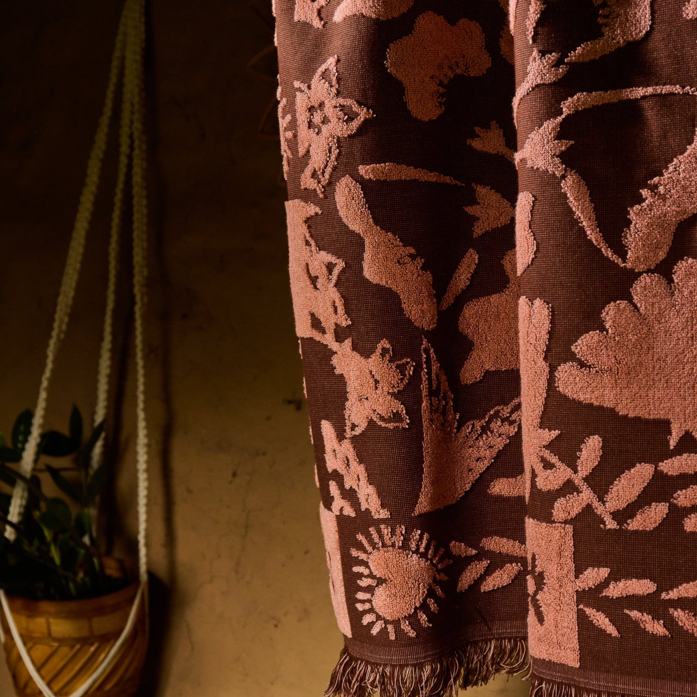 a burgundy and pink floral print bath towel.