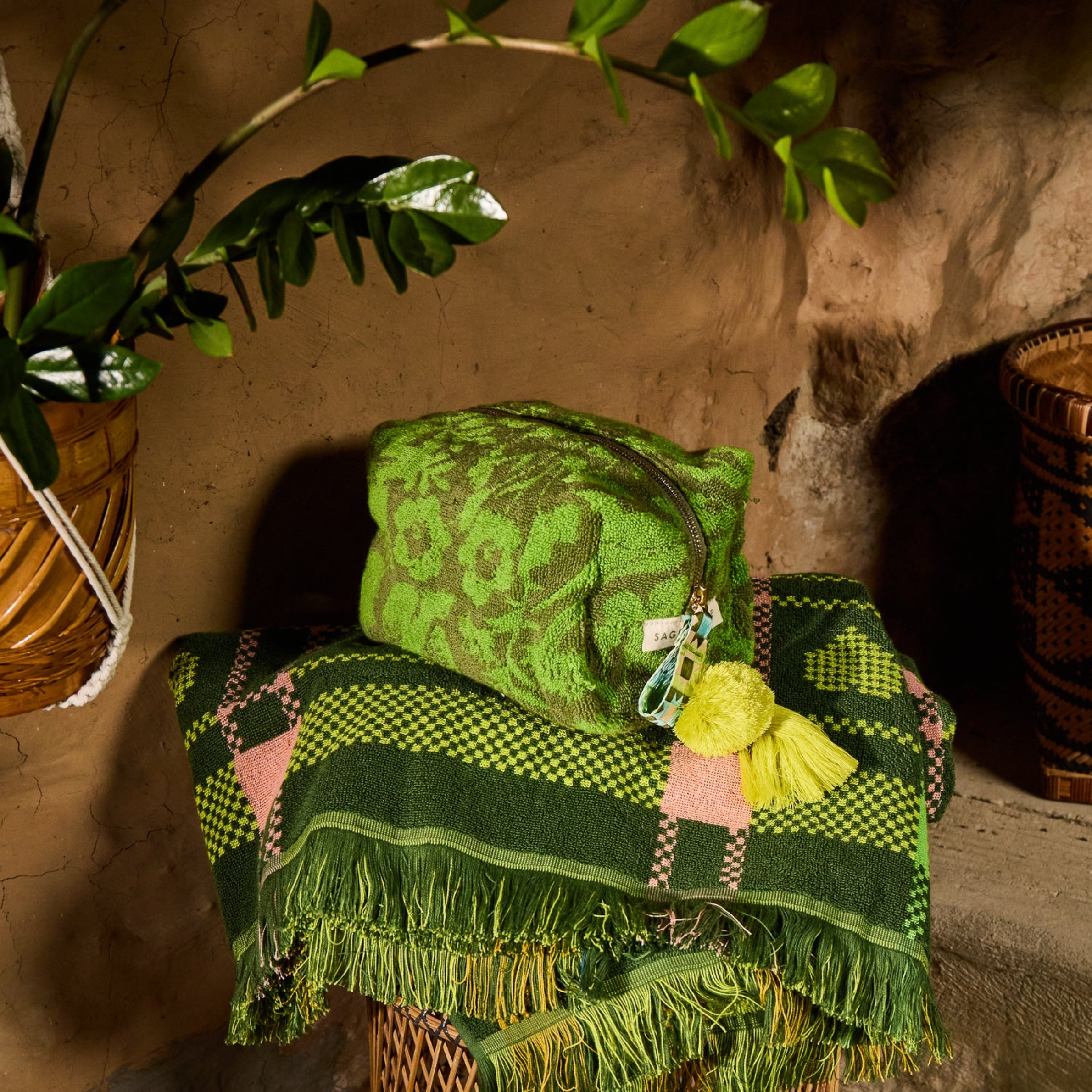 a green floral print terry cloth material pouch. 