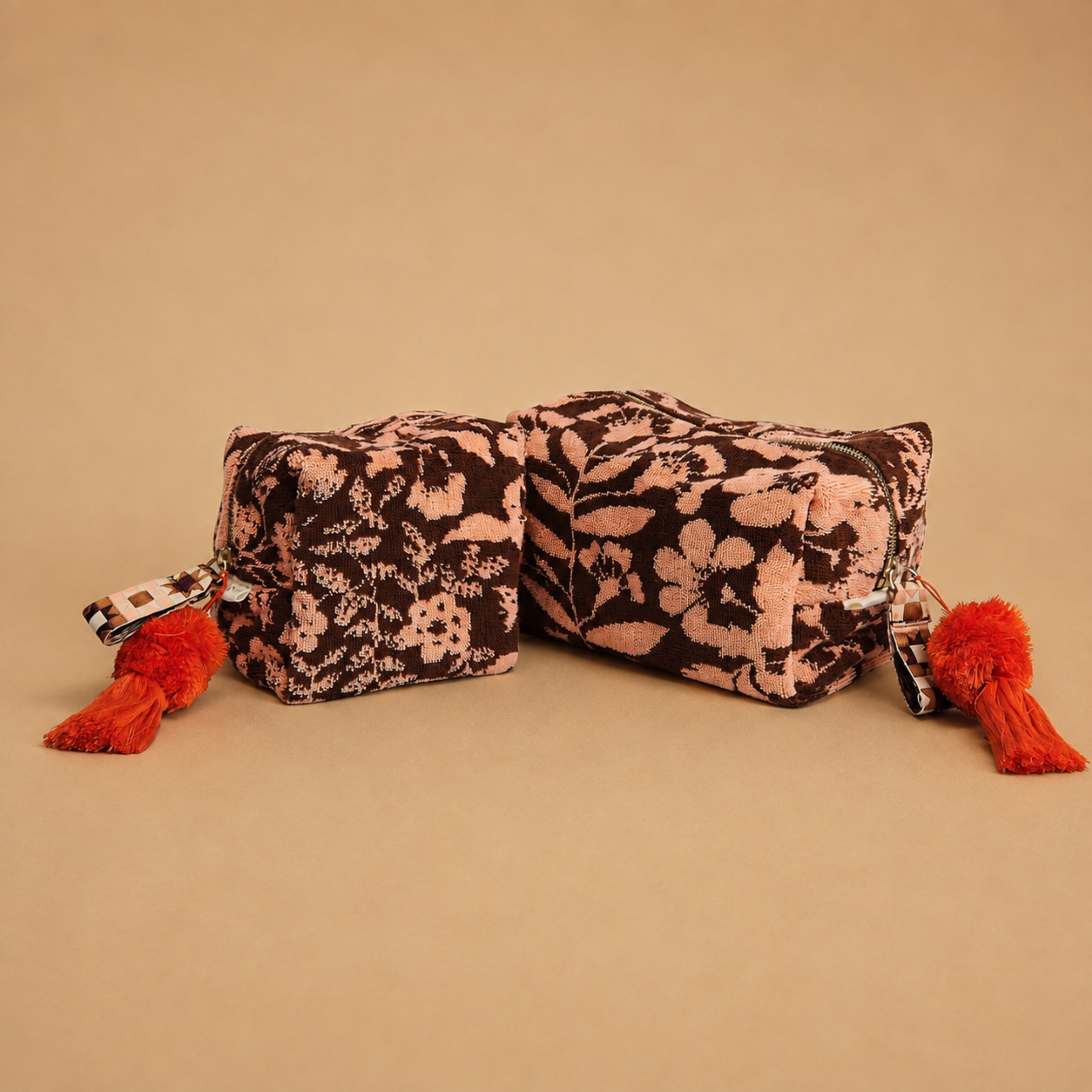 a burgundy/brownish and pink floral print terry cloth cosmetic pouch.