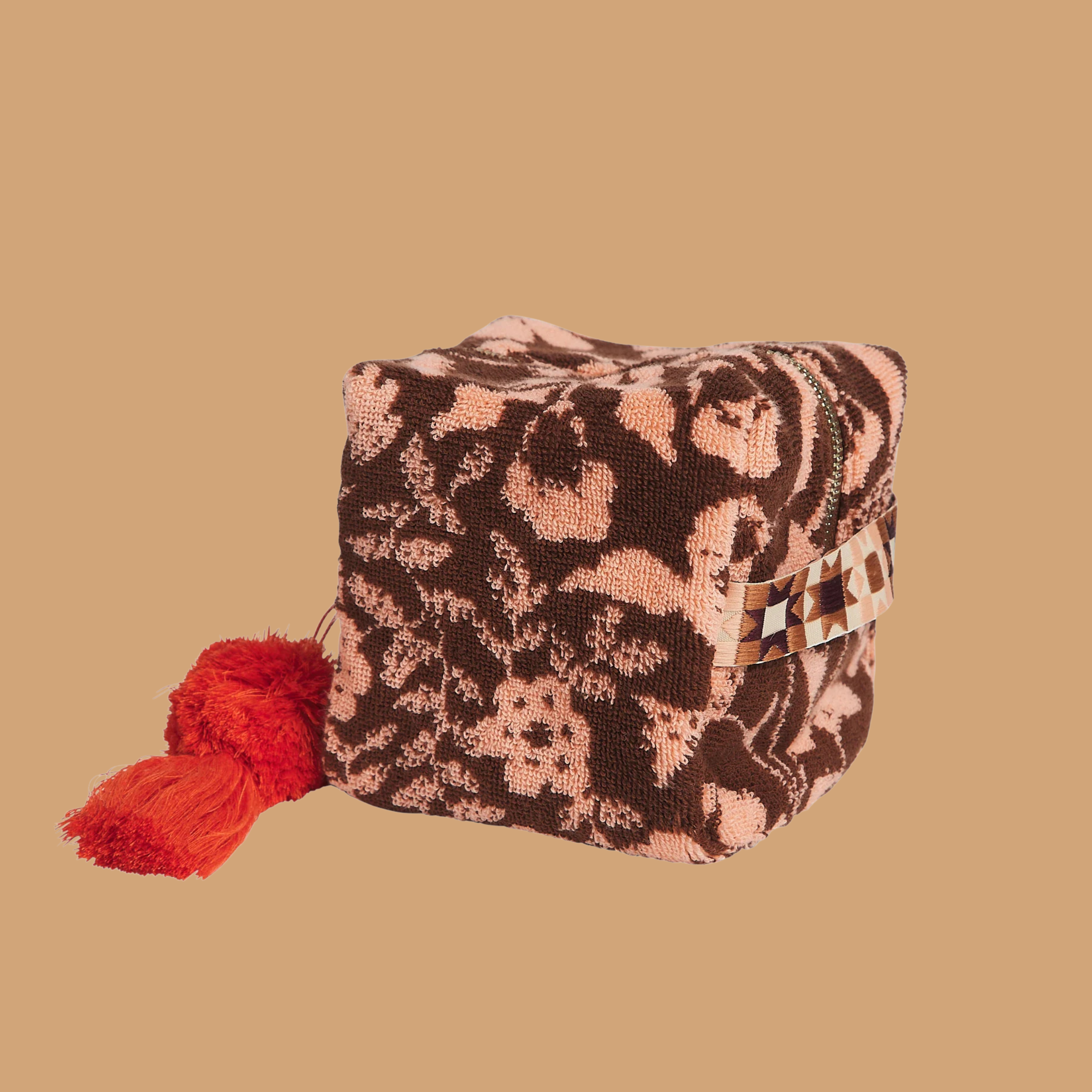 a burgundy/brownish and pink floral print terry cloth cosmetic pouch.