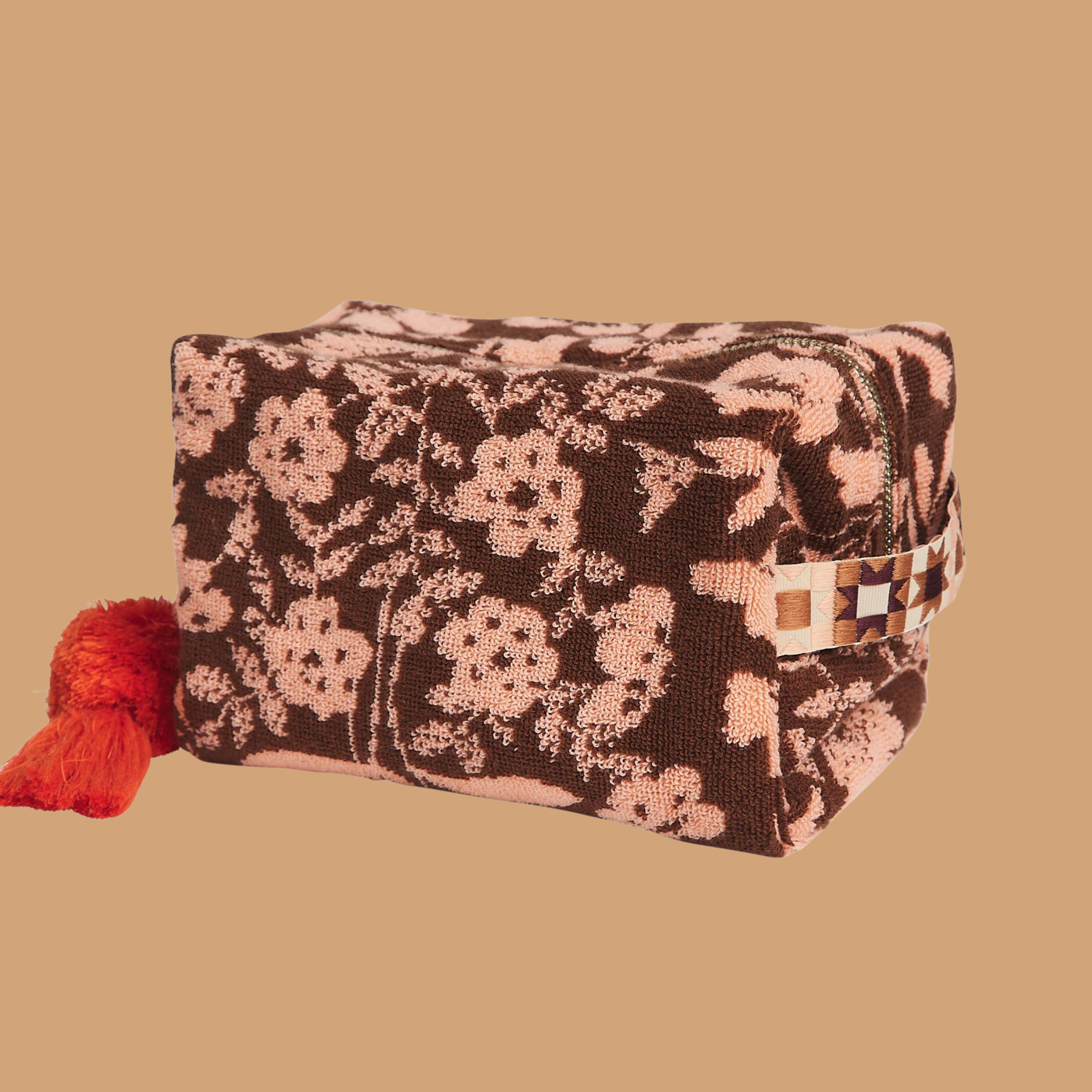 a burgundy/brownish and pink floral print terry cloth cosmetic pouch.