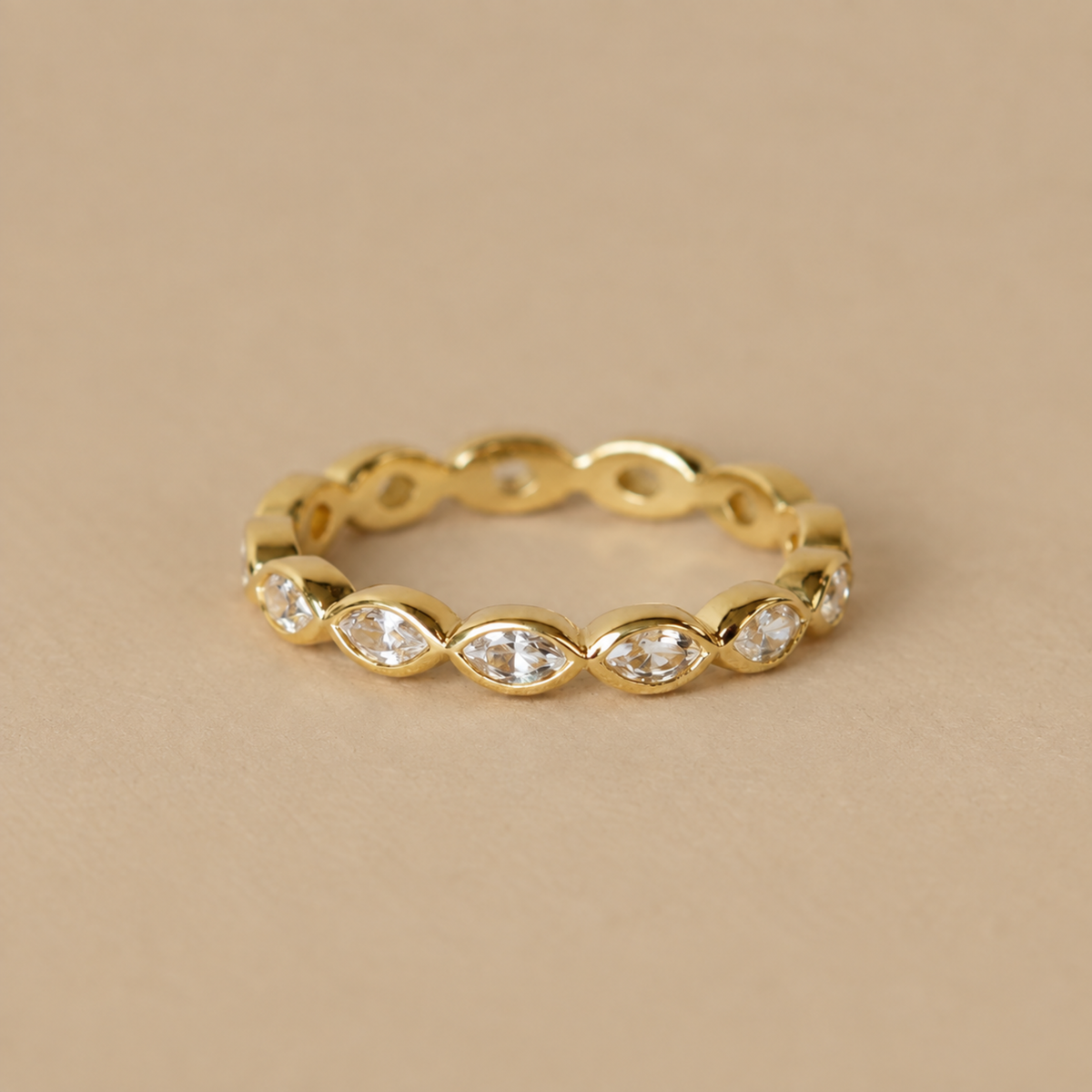 a gold ring with cz stones set within it.
