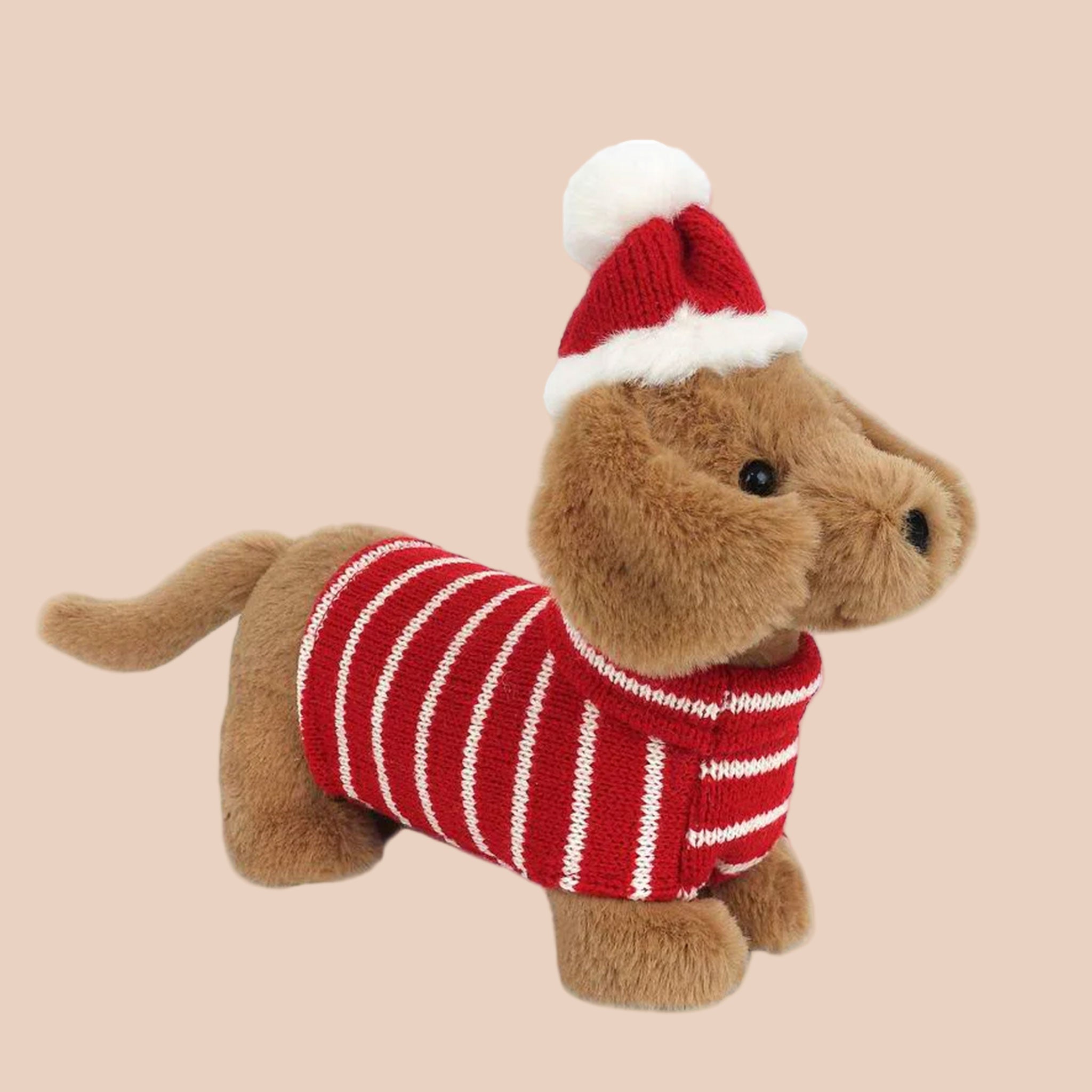 A dachshund puppy stuffed animal dressed in a red and white striped sweater and a red santa hat. 