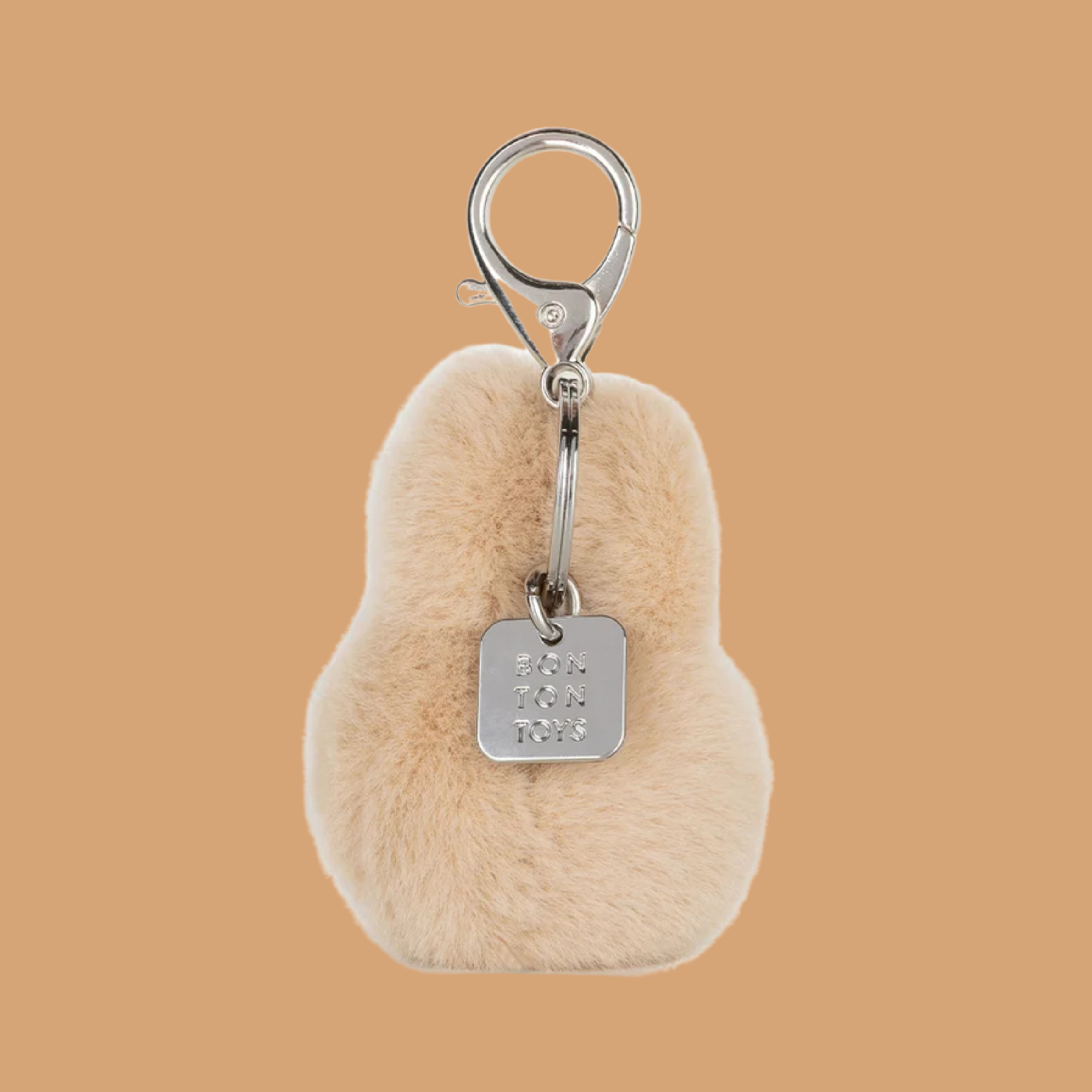 a beige miffy head shaped keychain