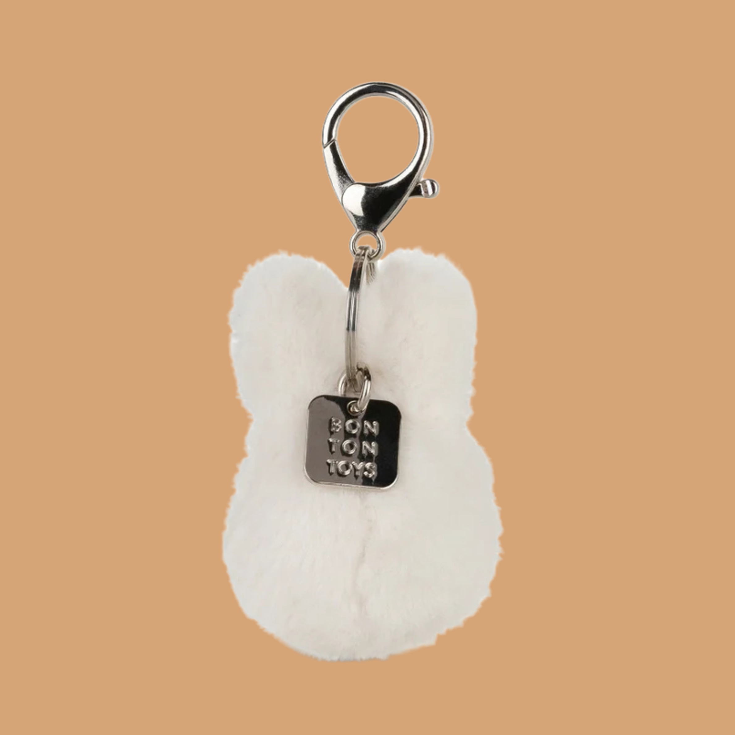 an off white fuzzy miffy character keychain