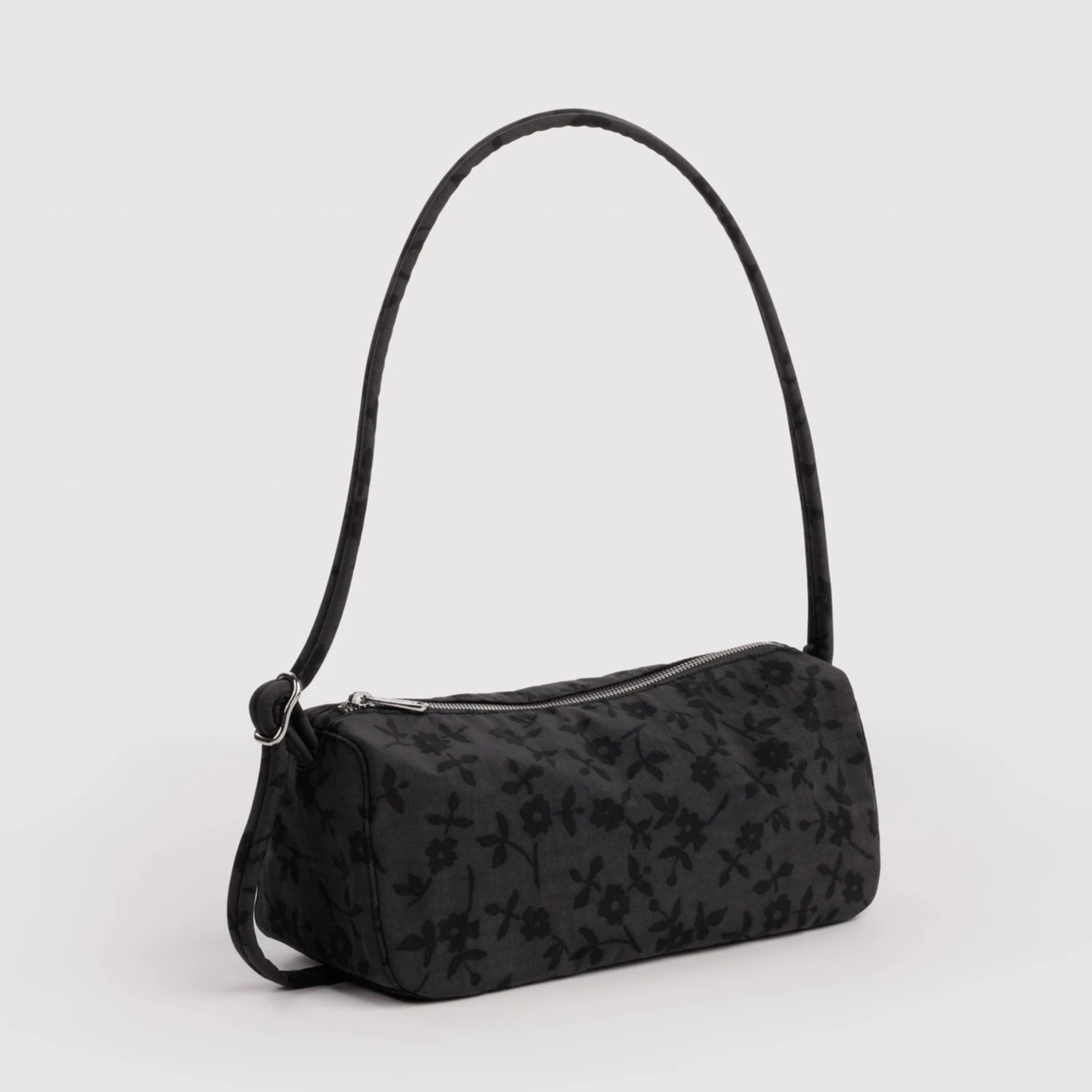 A charcoal shoulder bag with black floral print.