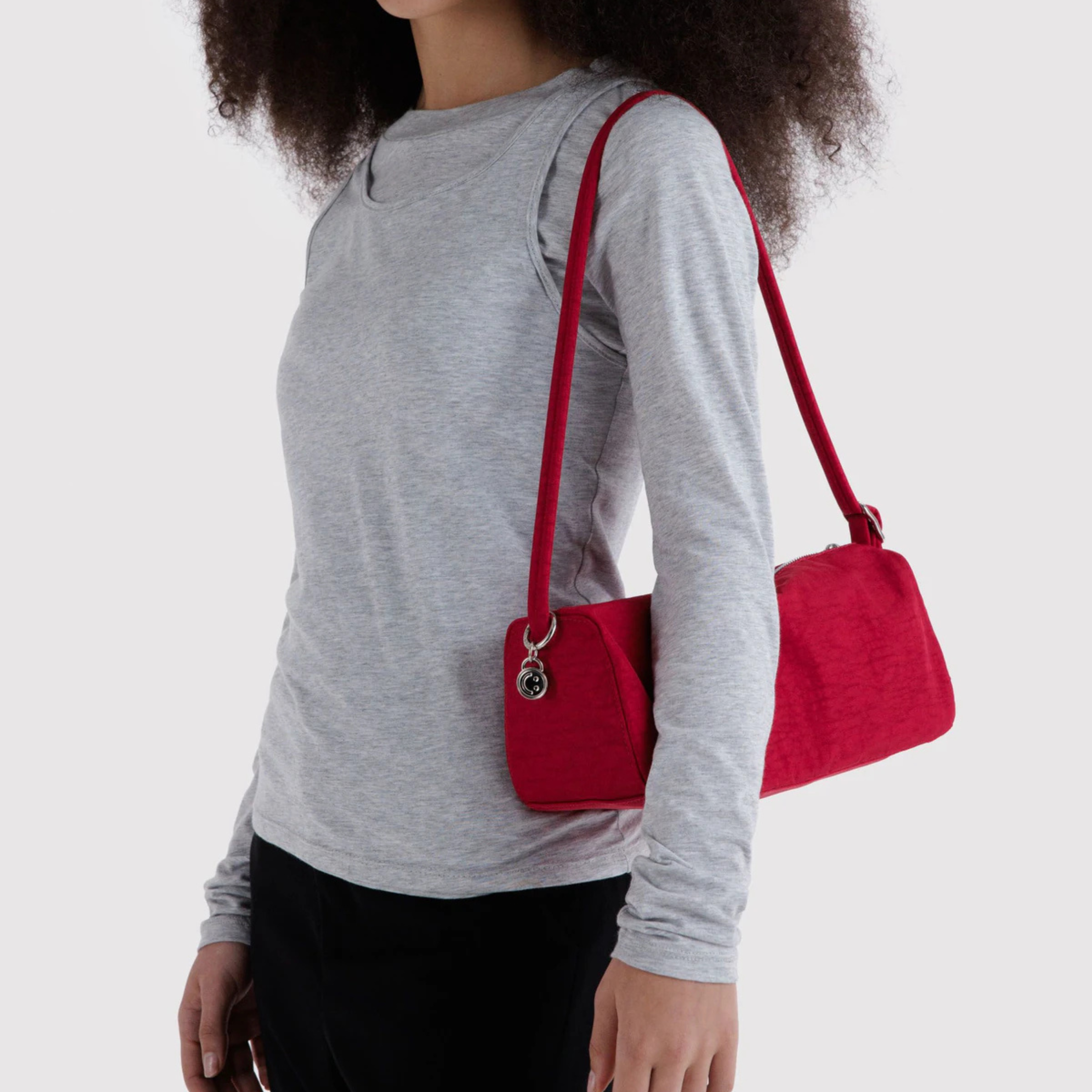 a red shoulder handbag. 