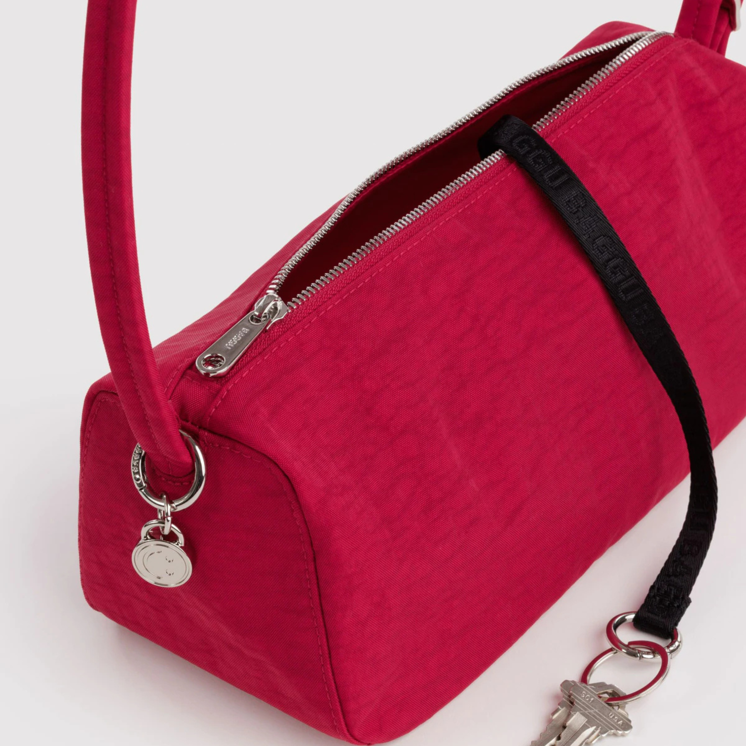 a red shoulder handbag. 