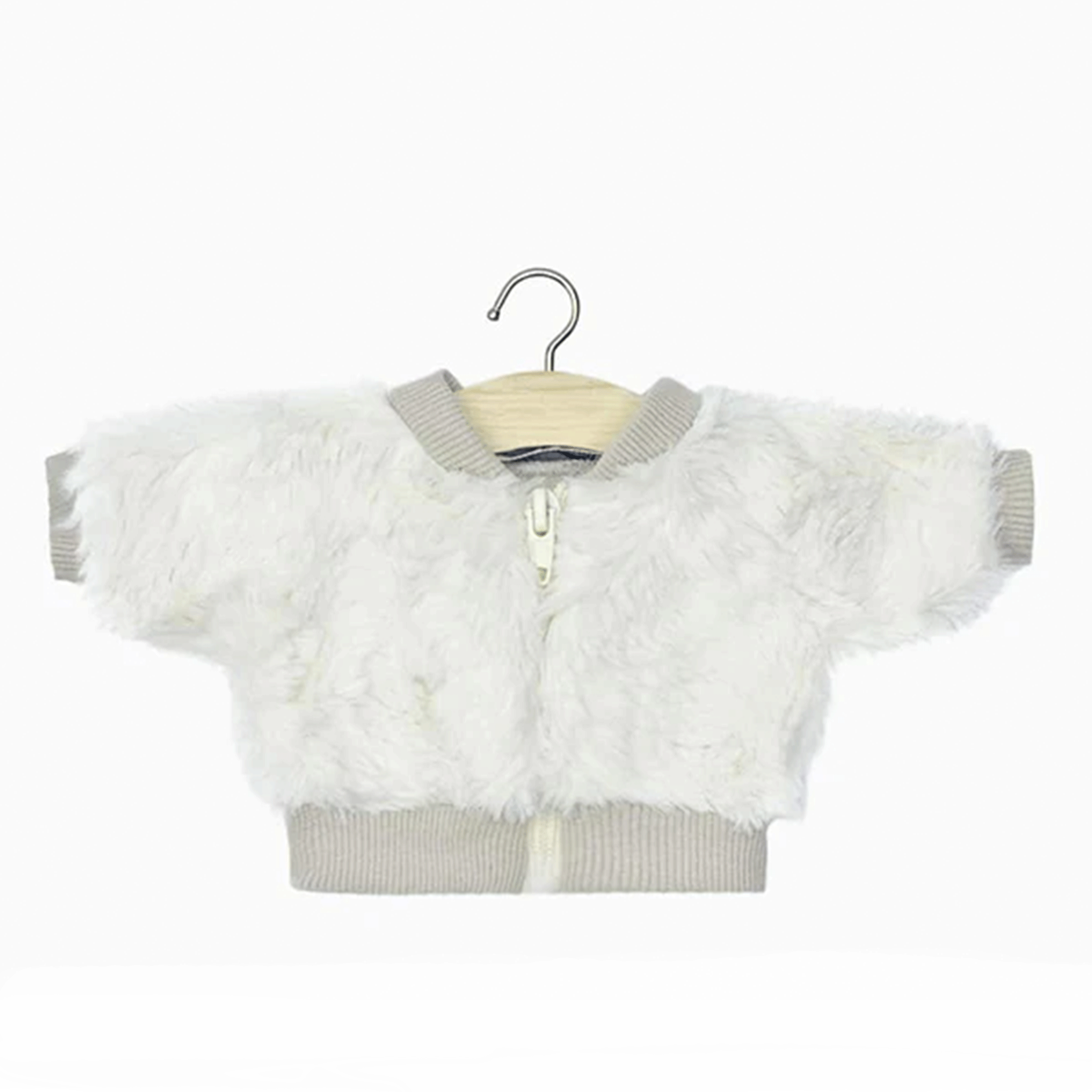 On a white background is a white faux fur jacket for Minikane dolls hung on a wood hanger. 