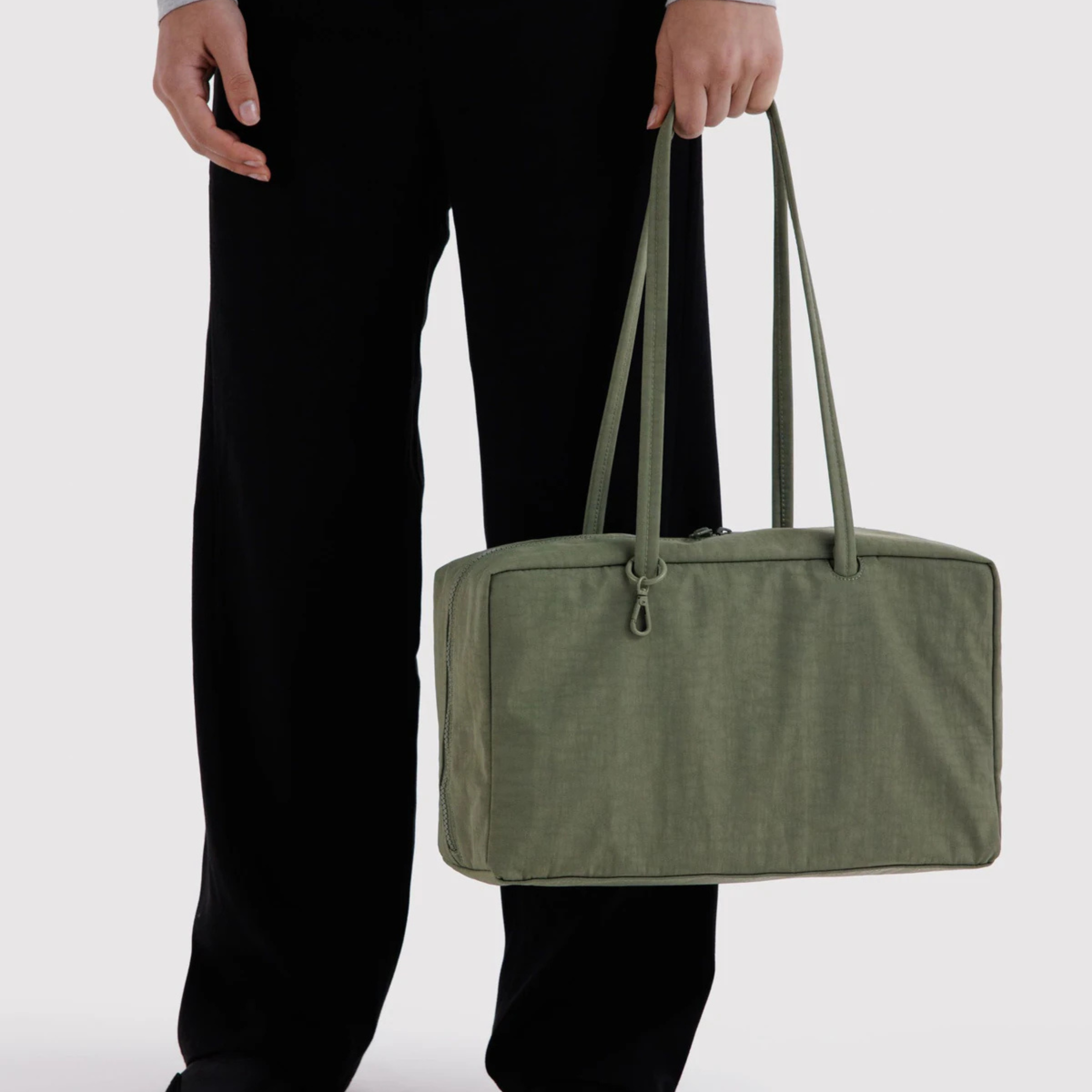 A green nylon shoulder bag. 
