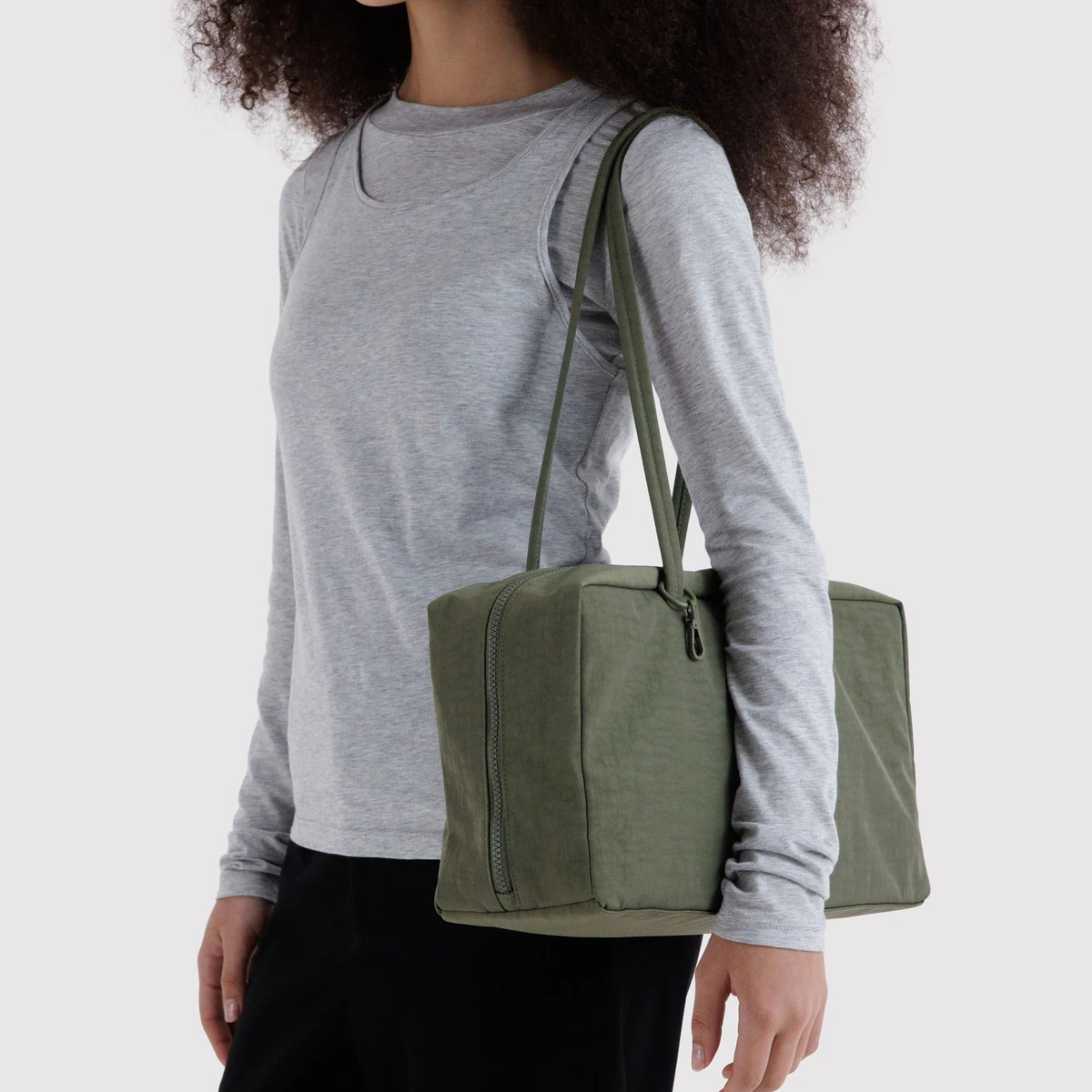 A green nylon shoulder bag. 