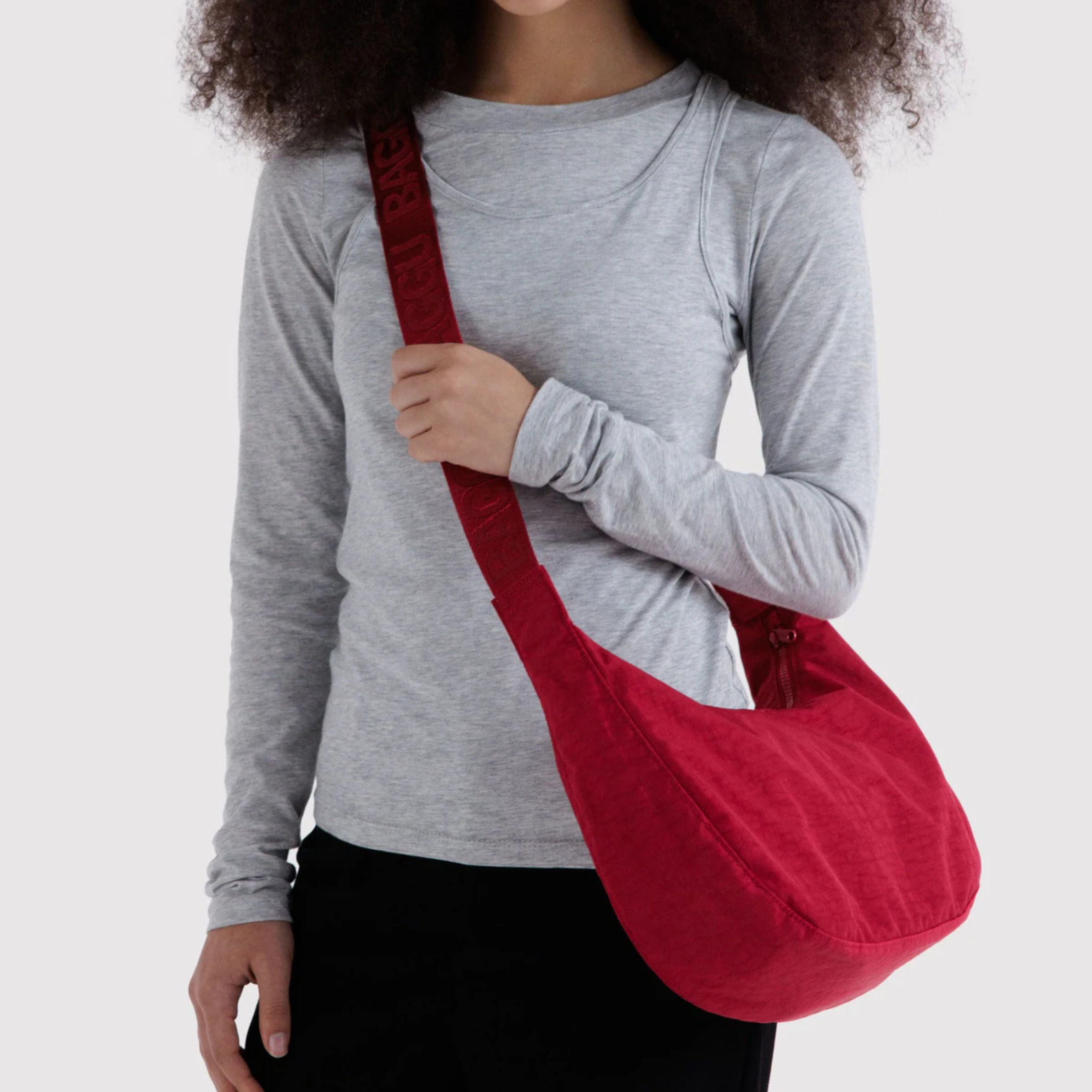 A red bag that can be a shoulder bag or a crossbody. 