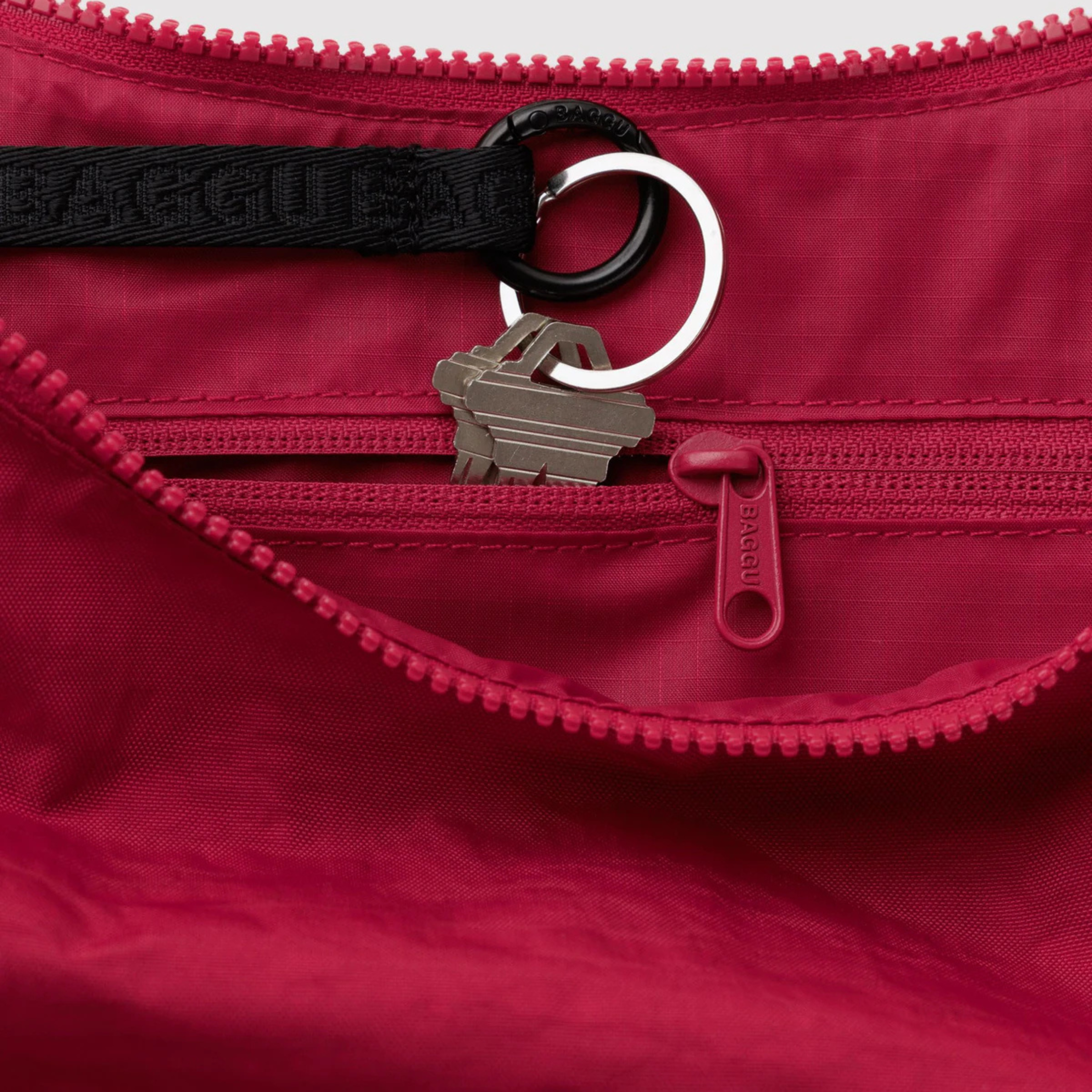 A red bag that can be a shoulder bag or a crossbody. 