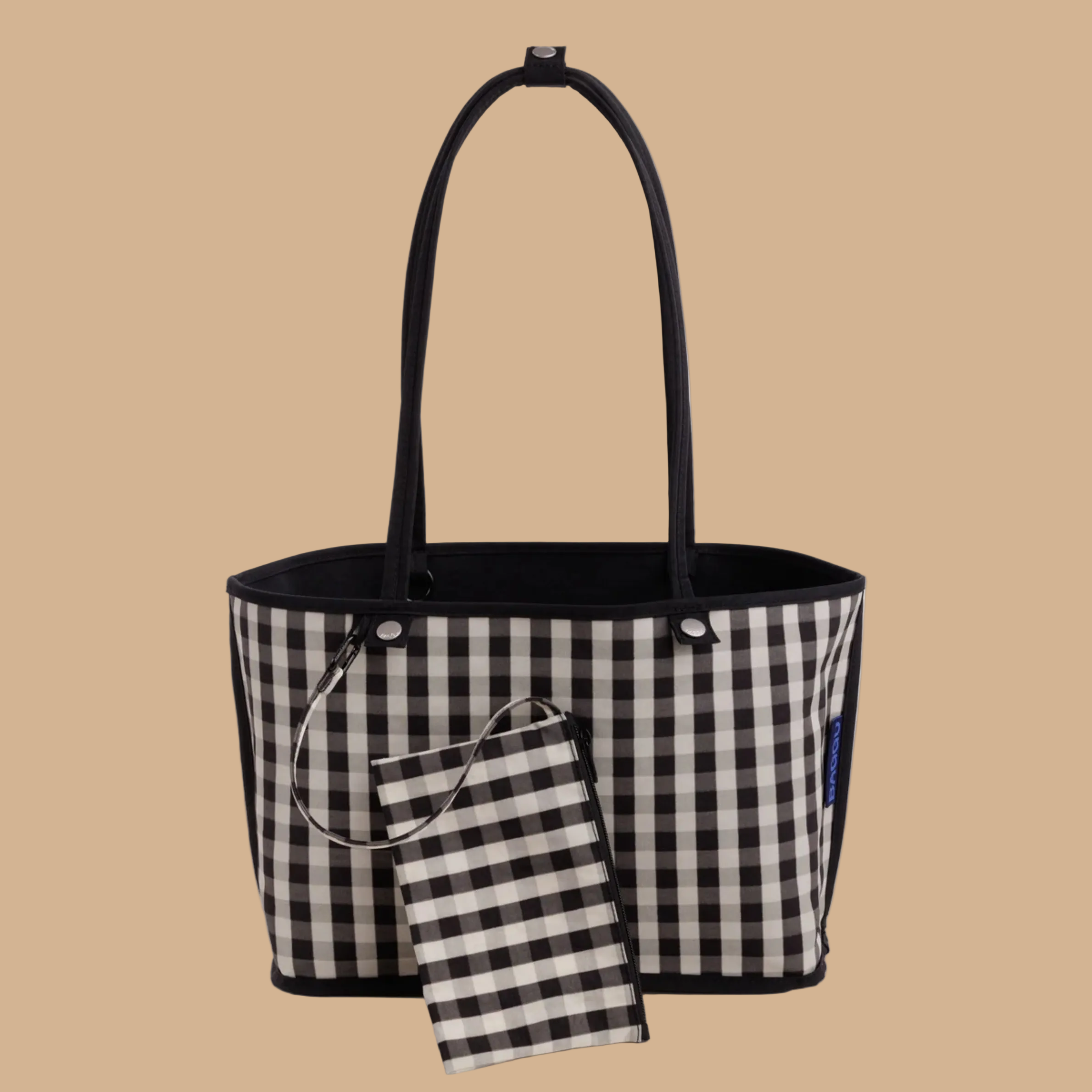 A black and black and white checkered reversible tote bag. 