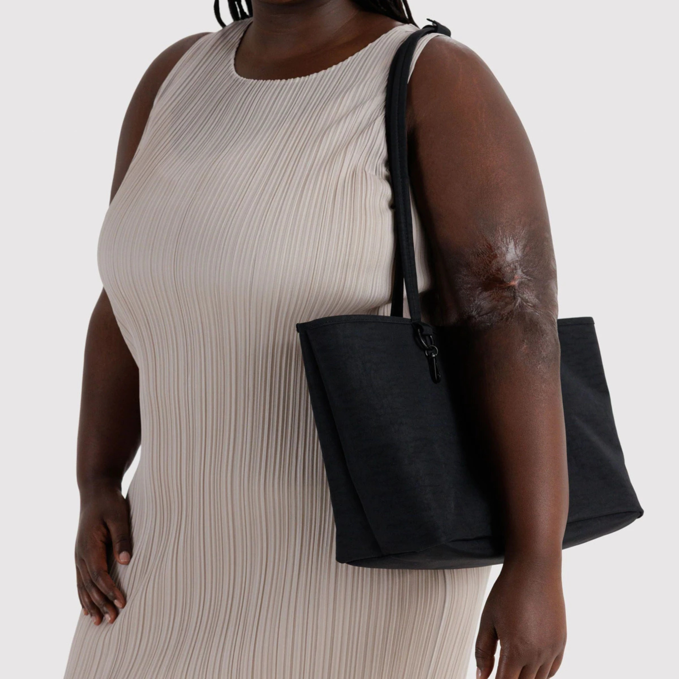 A black and black and white checkered reversible tote bag. 