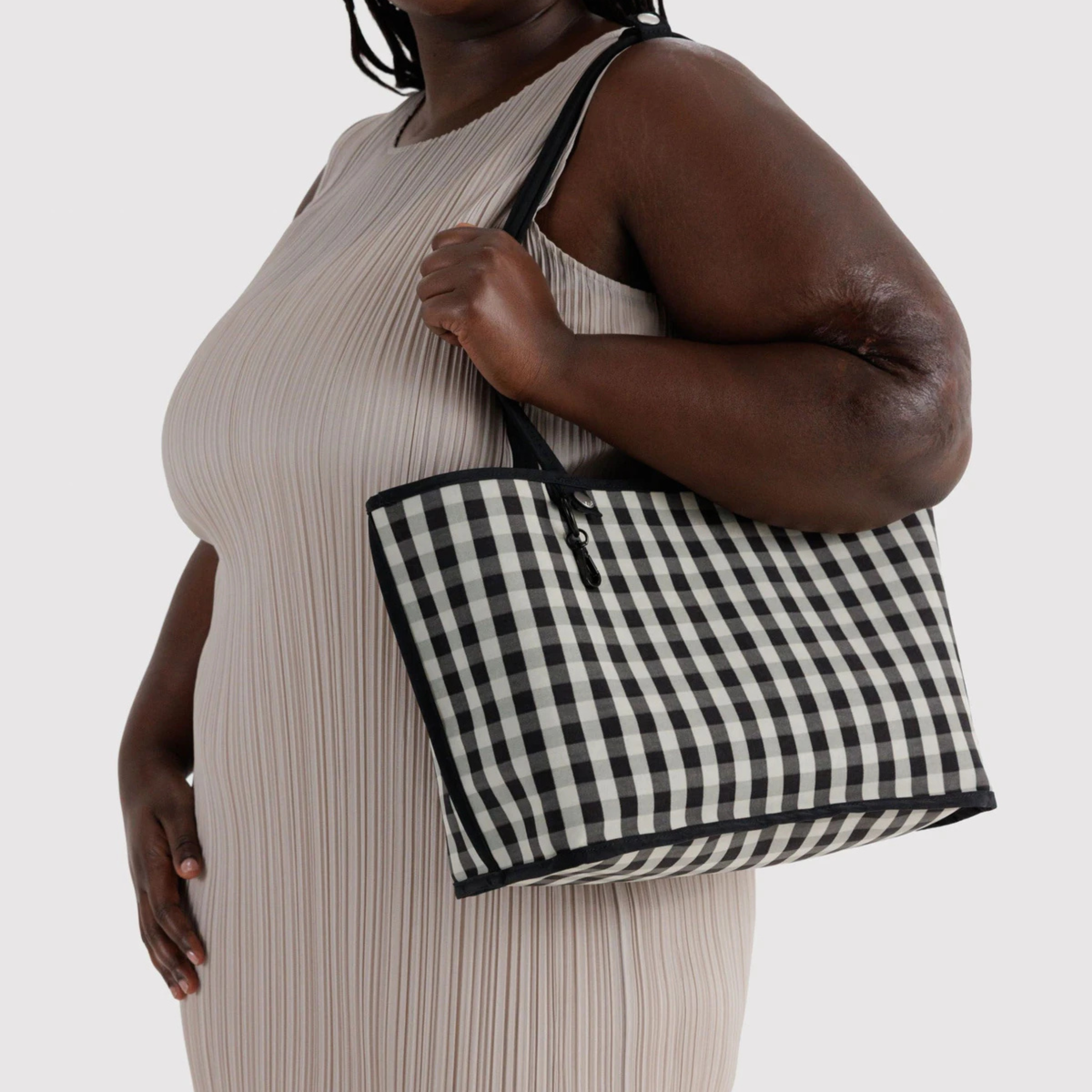 A black and black and white checkered reversible tote bag. 