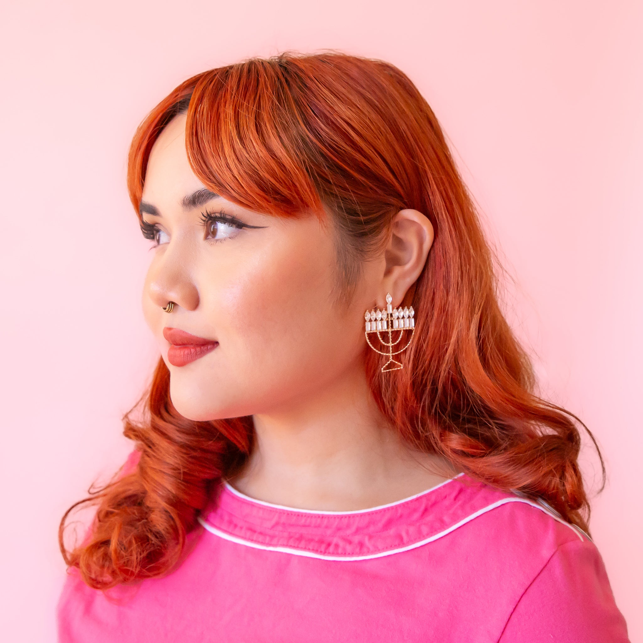 A model wearing the menorah shaped earrings. 