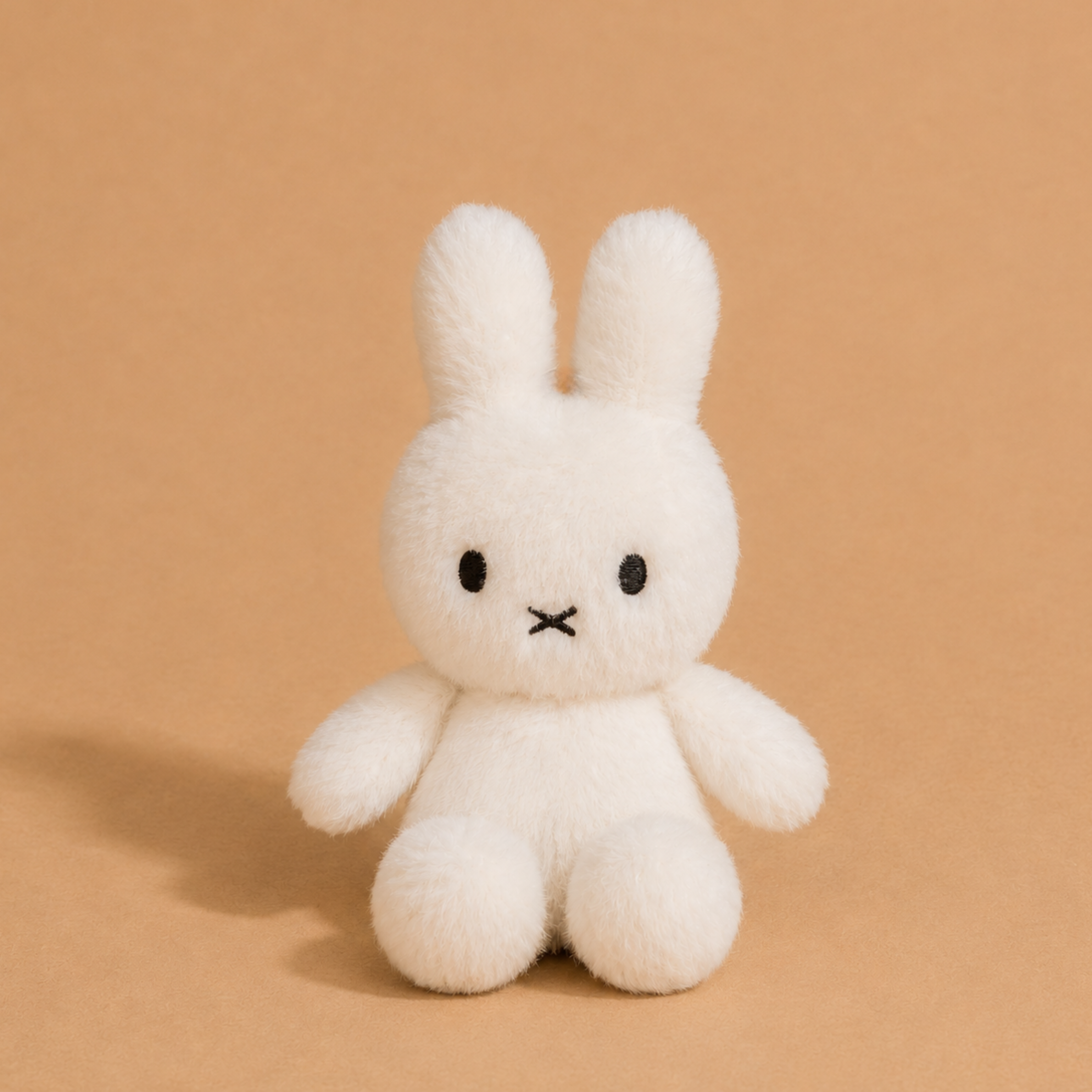 a white miffy shaped stuffed toy. 