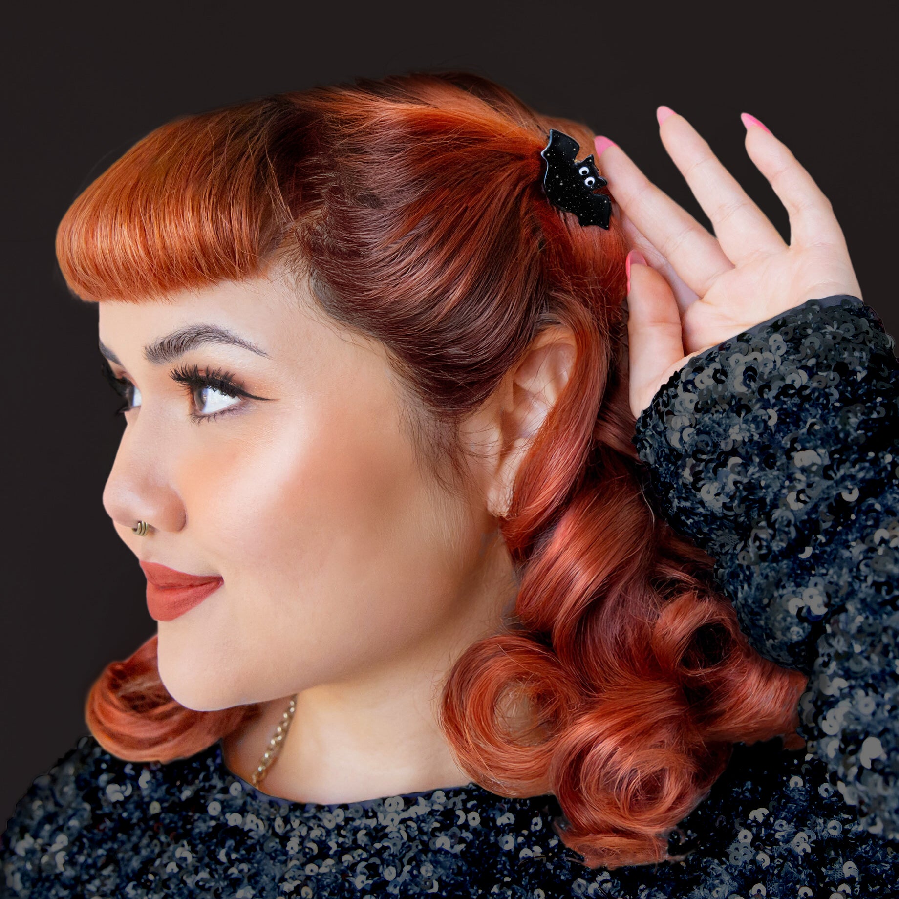 A black bat shaped mini hair clip. 