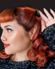 A black bat shaped mini hair clip. 
