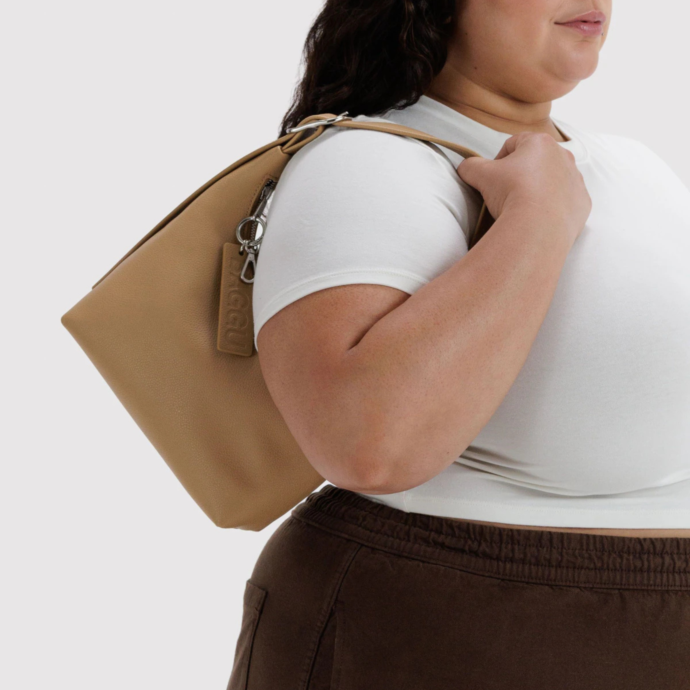 A small tan leather shoulder bag. 