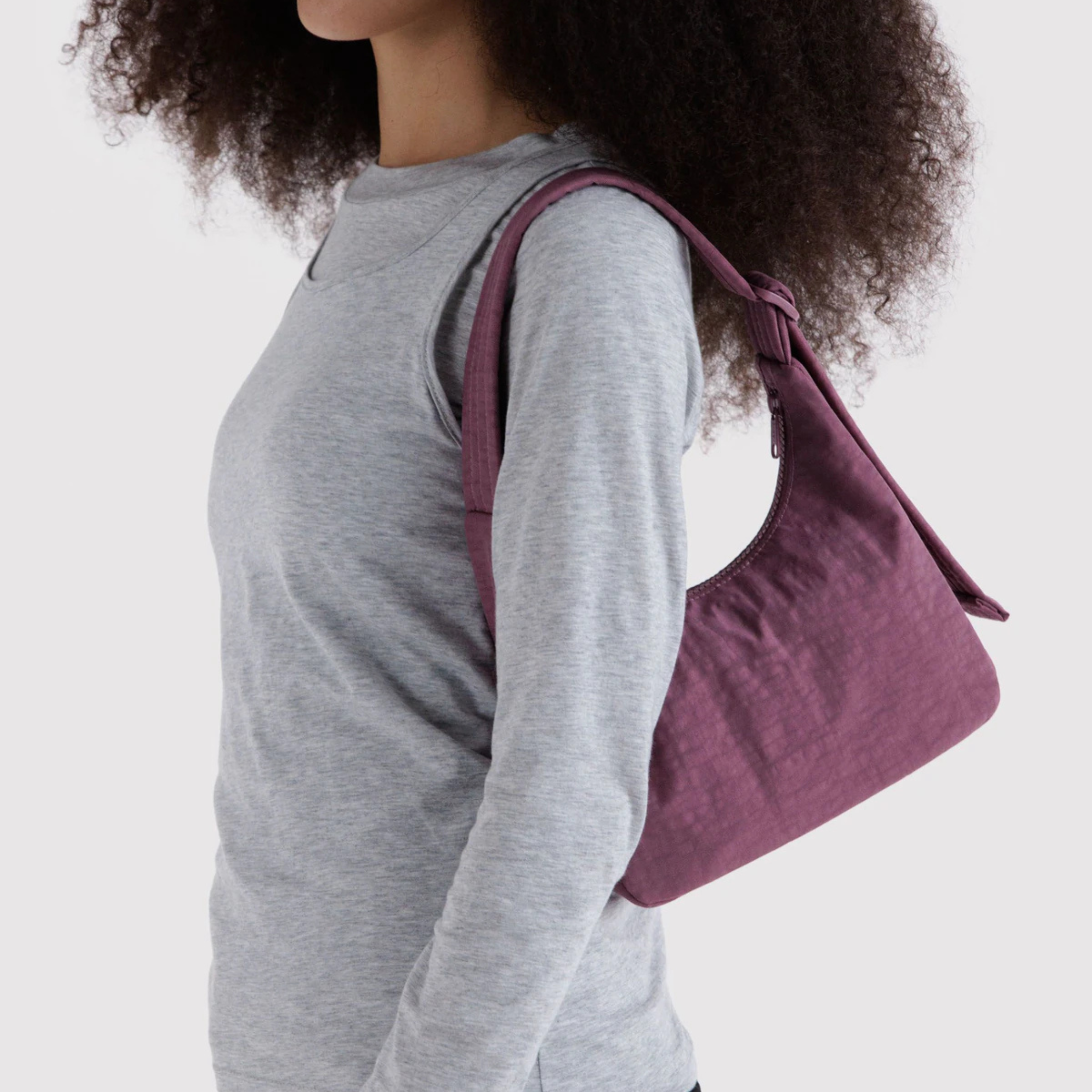 A purple nylon mini handbag.