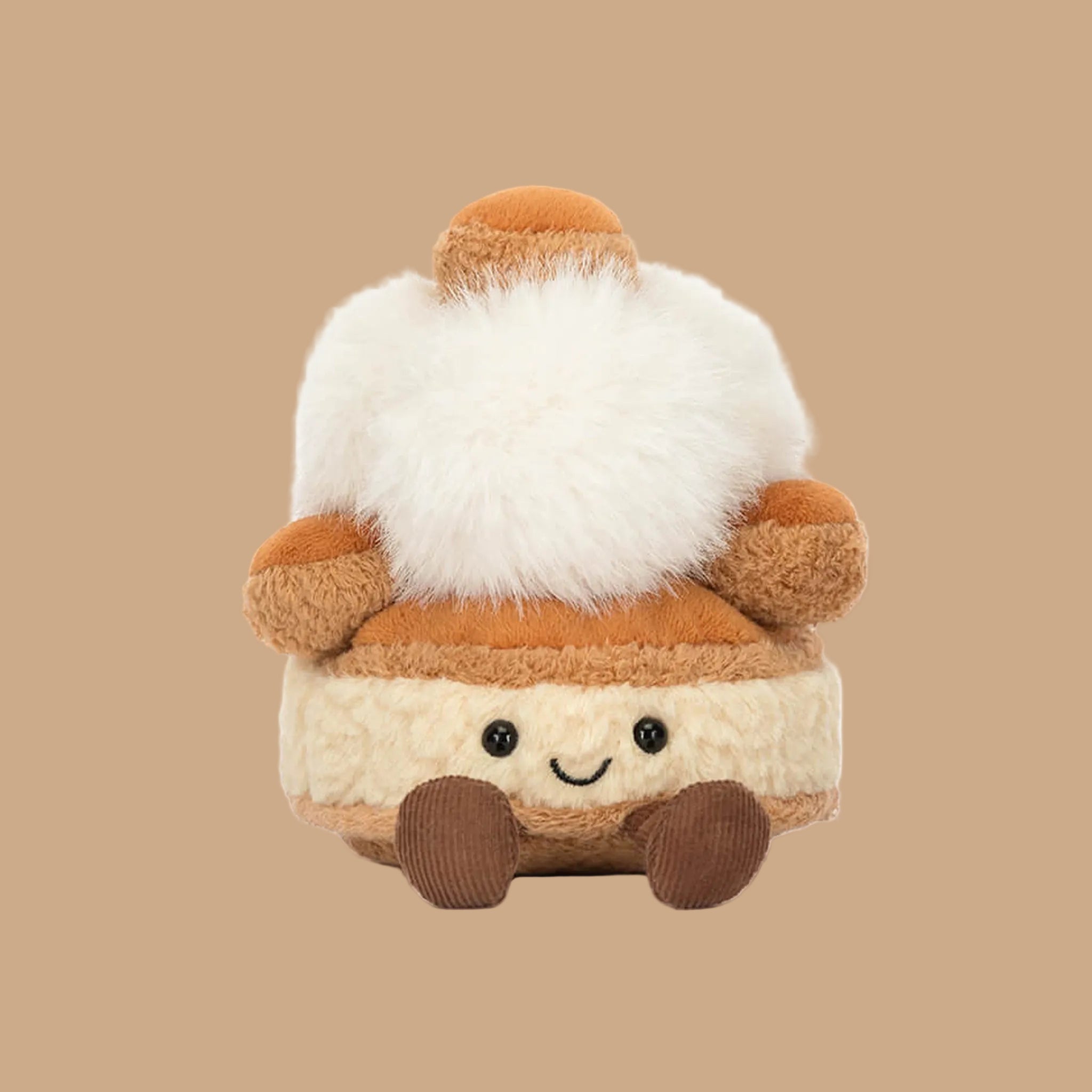 A brown, white and tan  stuffed toy with a smiling face and brown corduroy legs and feet. 